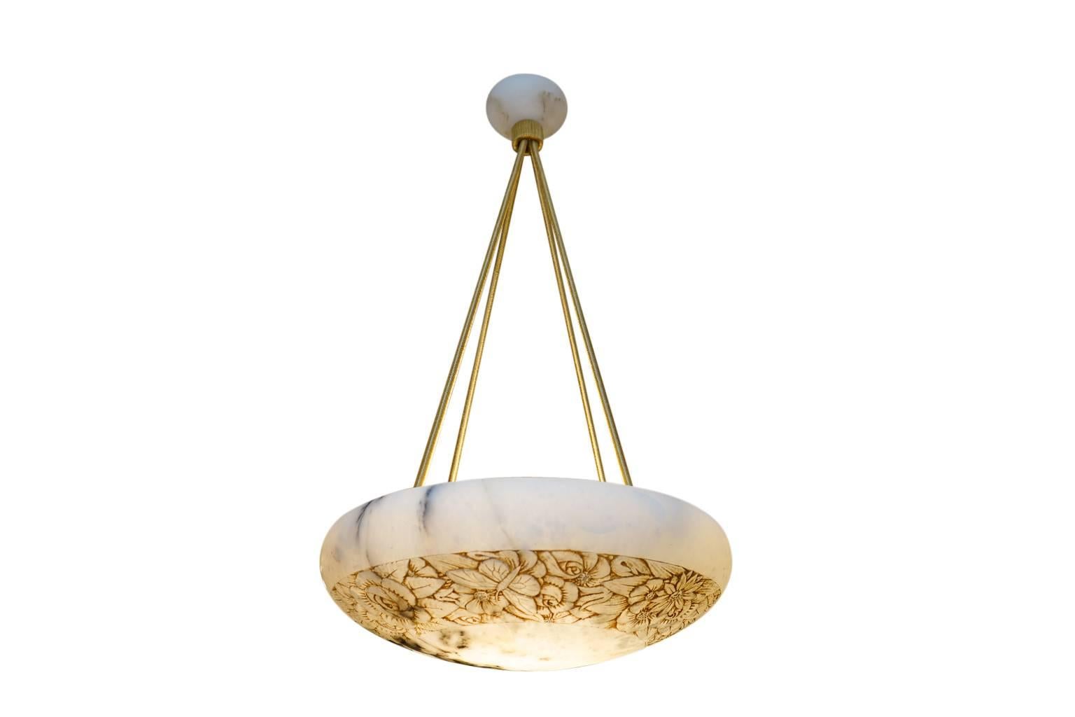 A seriously impressive pendant, carved of charcoal veined white alabaster with a thick centre band of intertwined flowers and butterflies give a light-hearted spin on a one-of-a-kind illuminated sculpture. Recently rewired, the light features a set