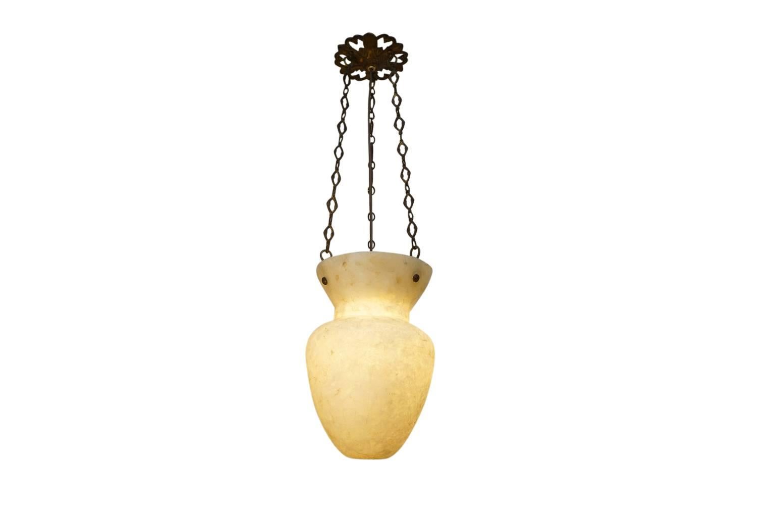 Suspended on antique chains, this ivory toned alabaster is fossilized and reminiscent of burled wood in texture. Although acquired in Sweden, the stone appears to be of Egyptian or Turkish in origin. The lantern holds one 100 watt equivalent LED