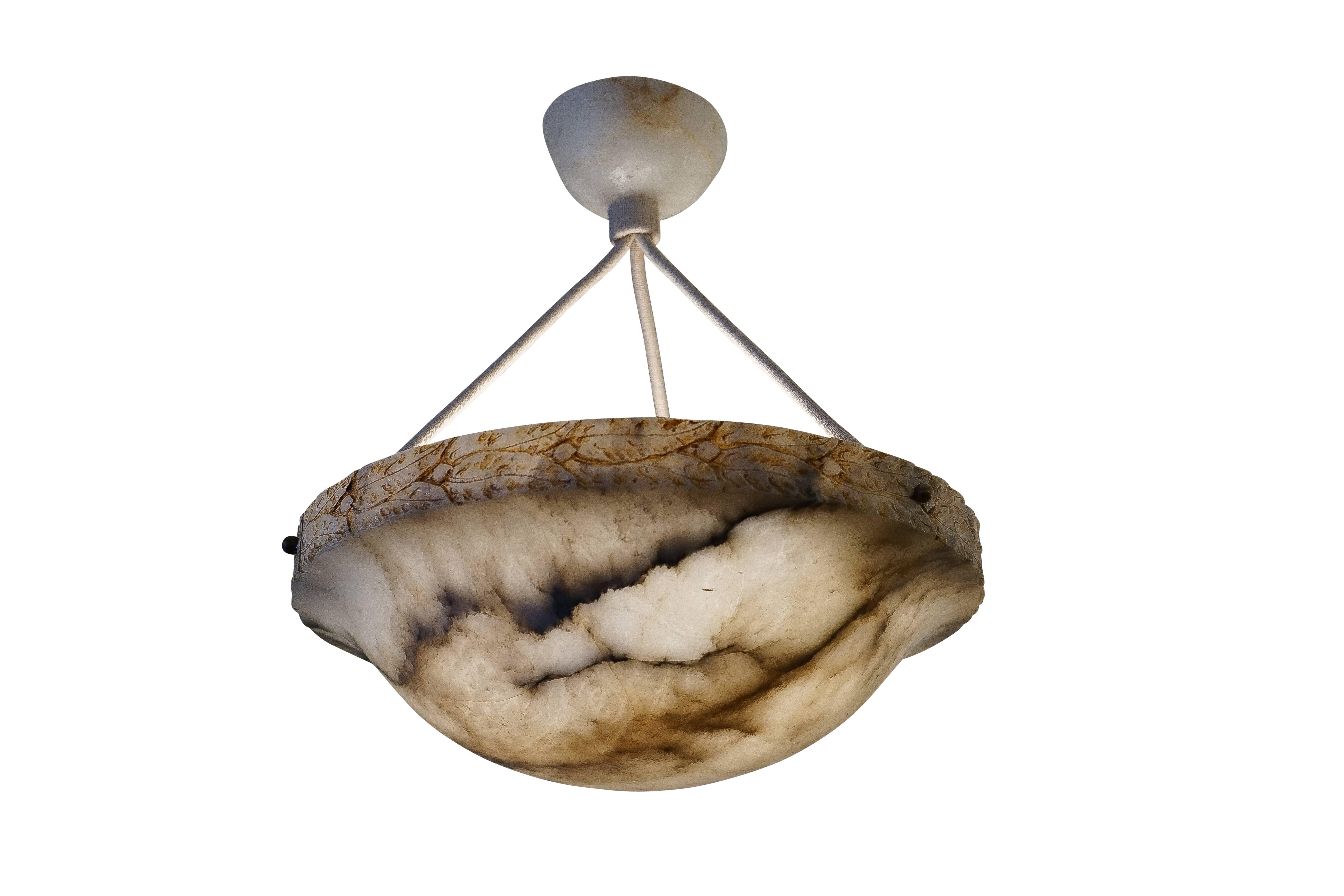 This petite light fixture has it all: Creamy white alabaster, deep mineral veining, a crisp hard edge wreathed with laurel, curving into a deep bowl. Holding three 25 watt incandescent bulbs or three led bulbs of any wattage, this is perfect for a