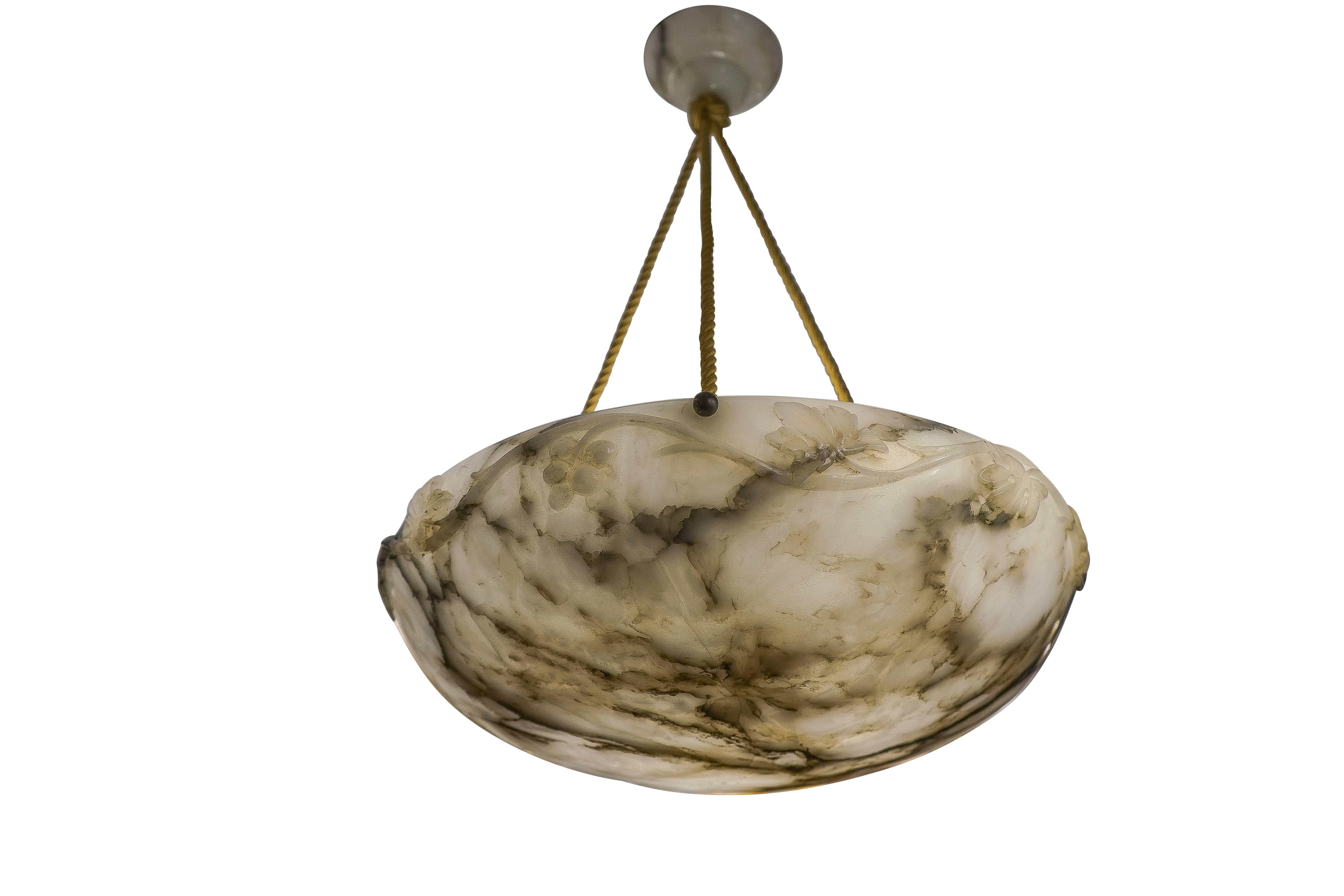 Why not add a little drama? This stunning white alabaster light fixture is entwined with vines, leaves and yes, grapes! The deep, charcoal mineral veining makes this one of our most interesting light fixtures to ponder. Holds three 60 watt