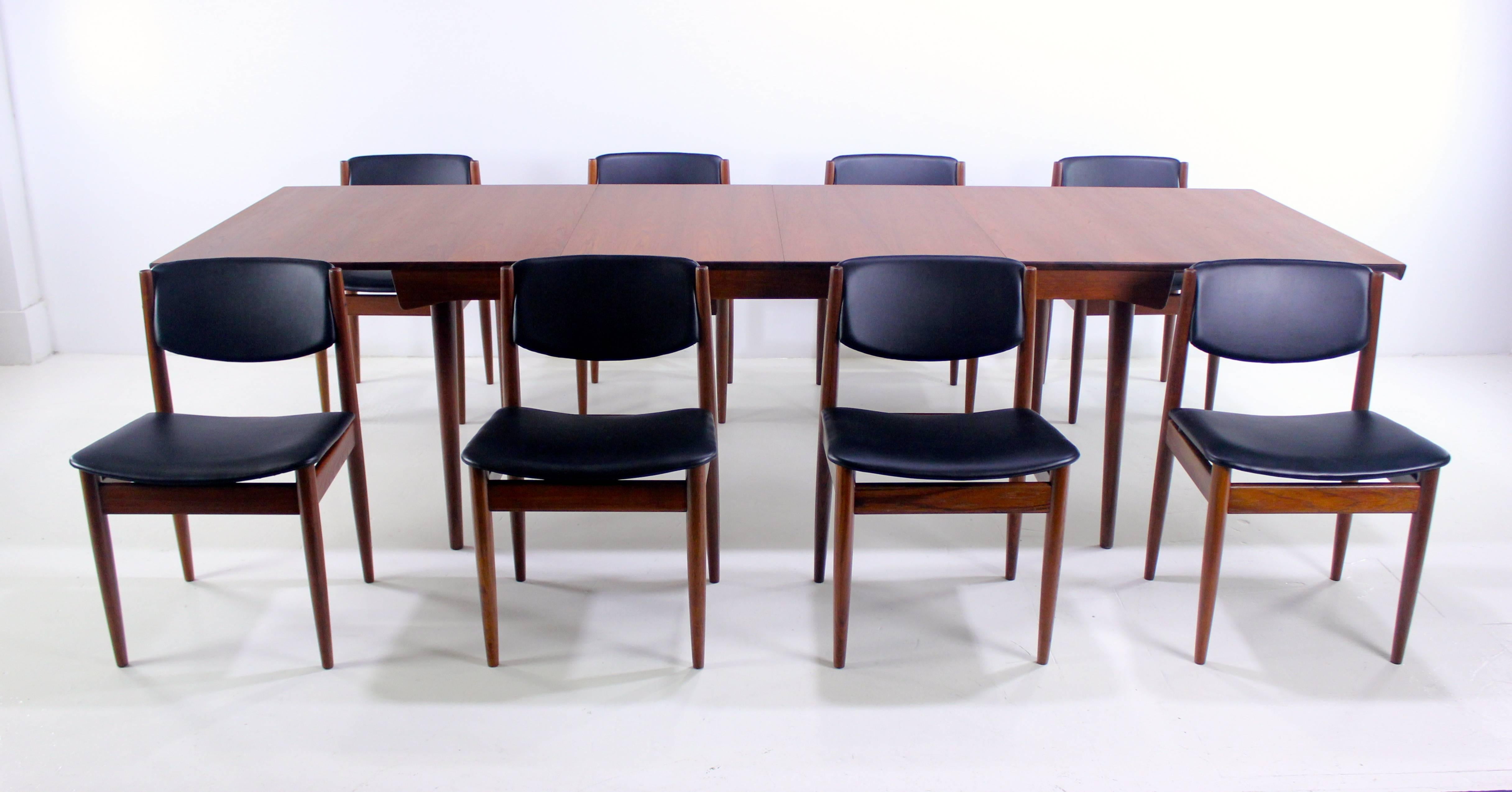 High-style Danish modern dining table with eight chairs designed by Finn Juhl.
France & Son, maker.
Richly grained teak.
Table, model #FD-540, has two 19.5" leaves providing a full extension of 112".
Eight chairs, measuring