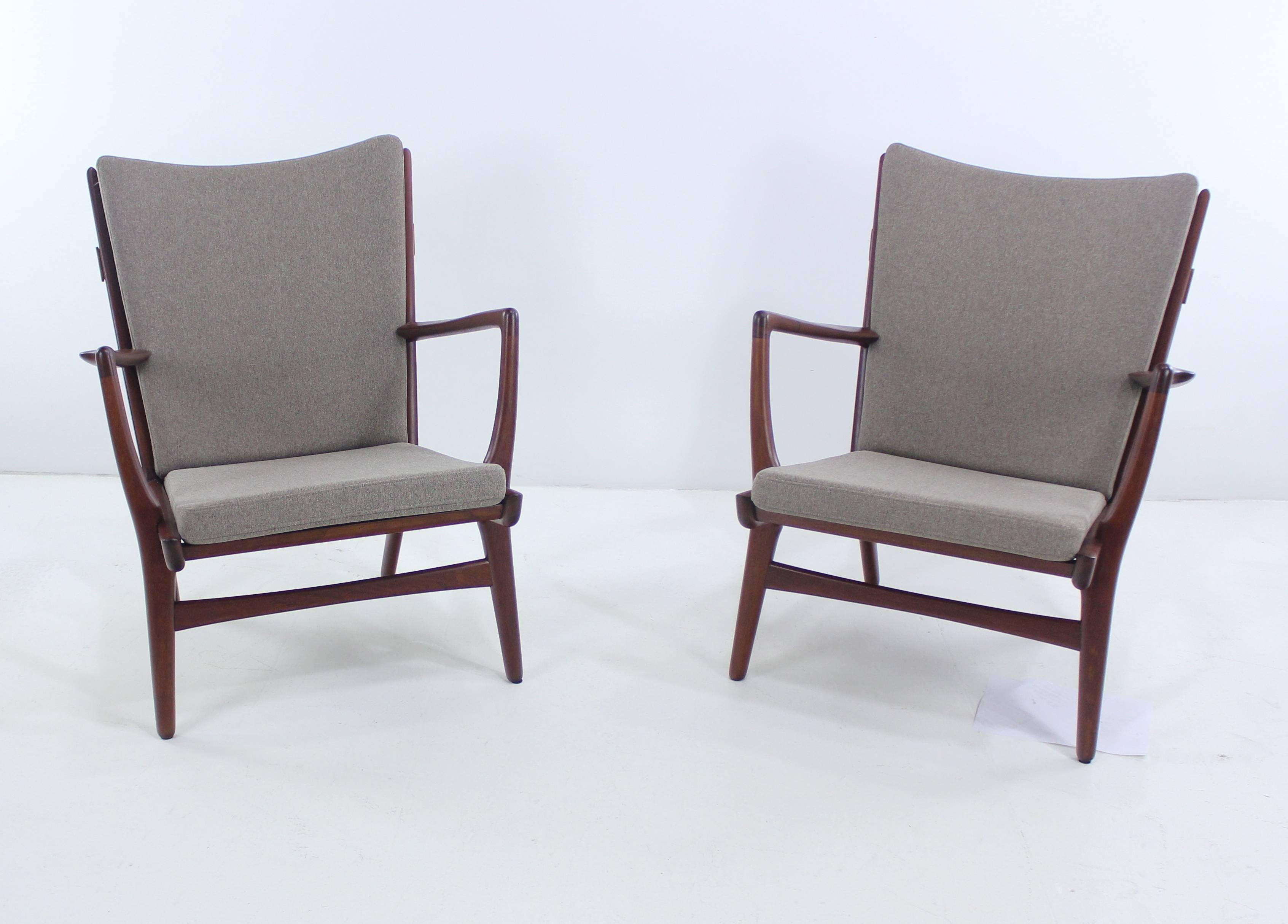 Two extraordinary Danish modern armchairs designed by Hans Wegner.
AP Stollen, maker. 1951.
Rich teak frames with dramatically flared sculptural Silhouettes.
Newly upholstered in highest quality period fabric.
Ultimate comfort and