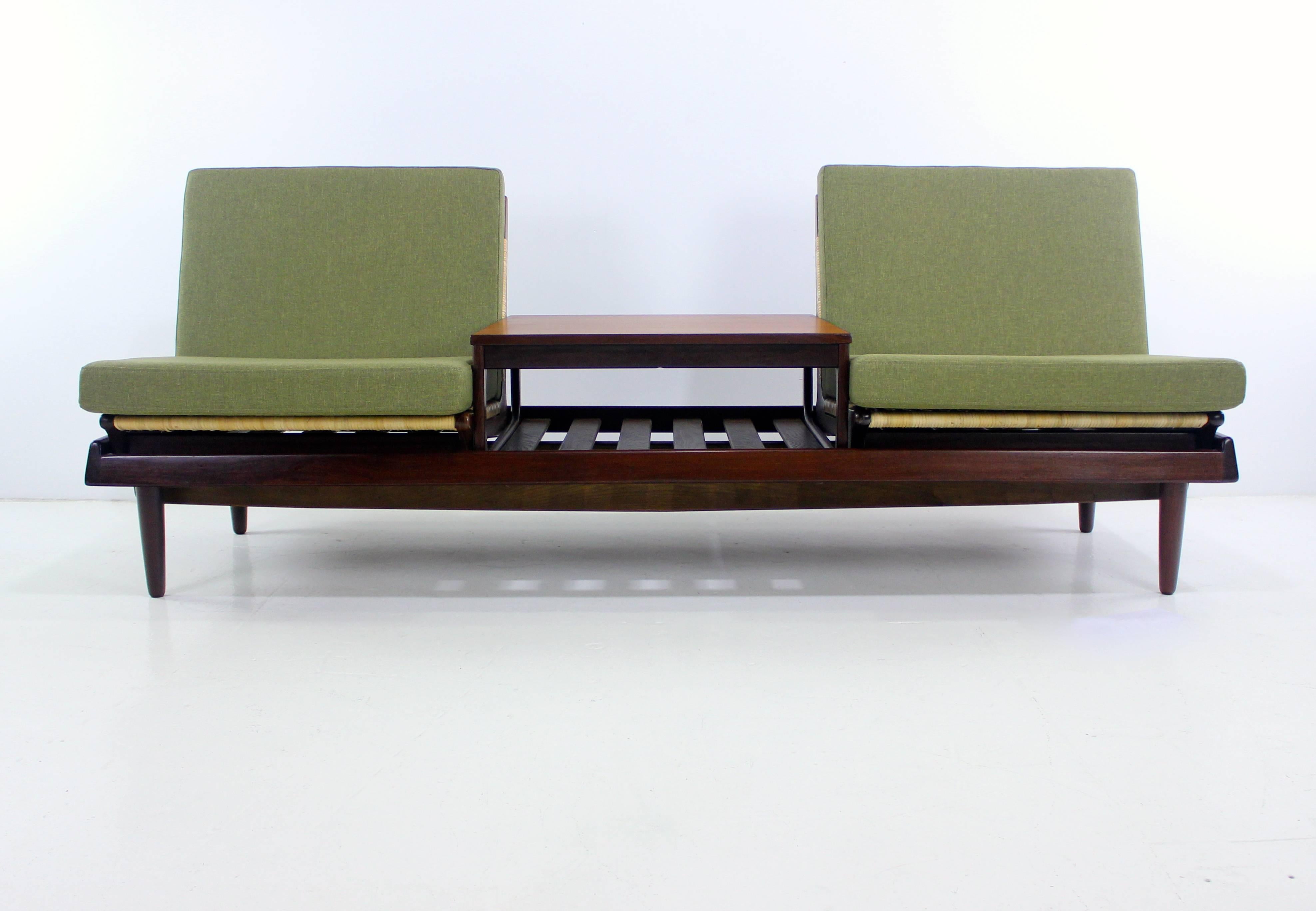 Danish modern seating group designed by Hans Olsen.
Bramin, maker. Model TV 161.
Richly grained teak frame.
Composed of four separate pieces including:
Two newly caned chairs.
Bench with four removable cushions newly upholstered in highest