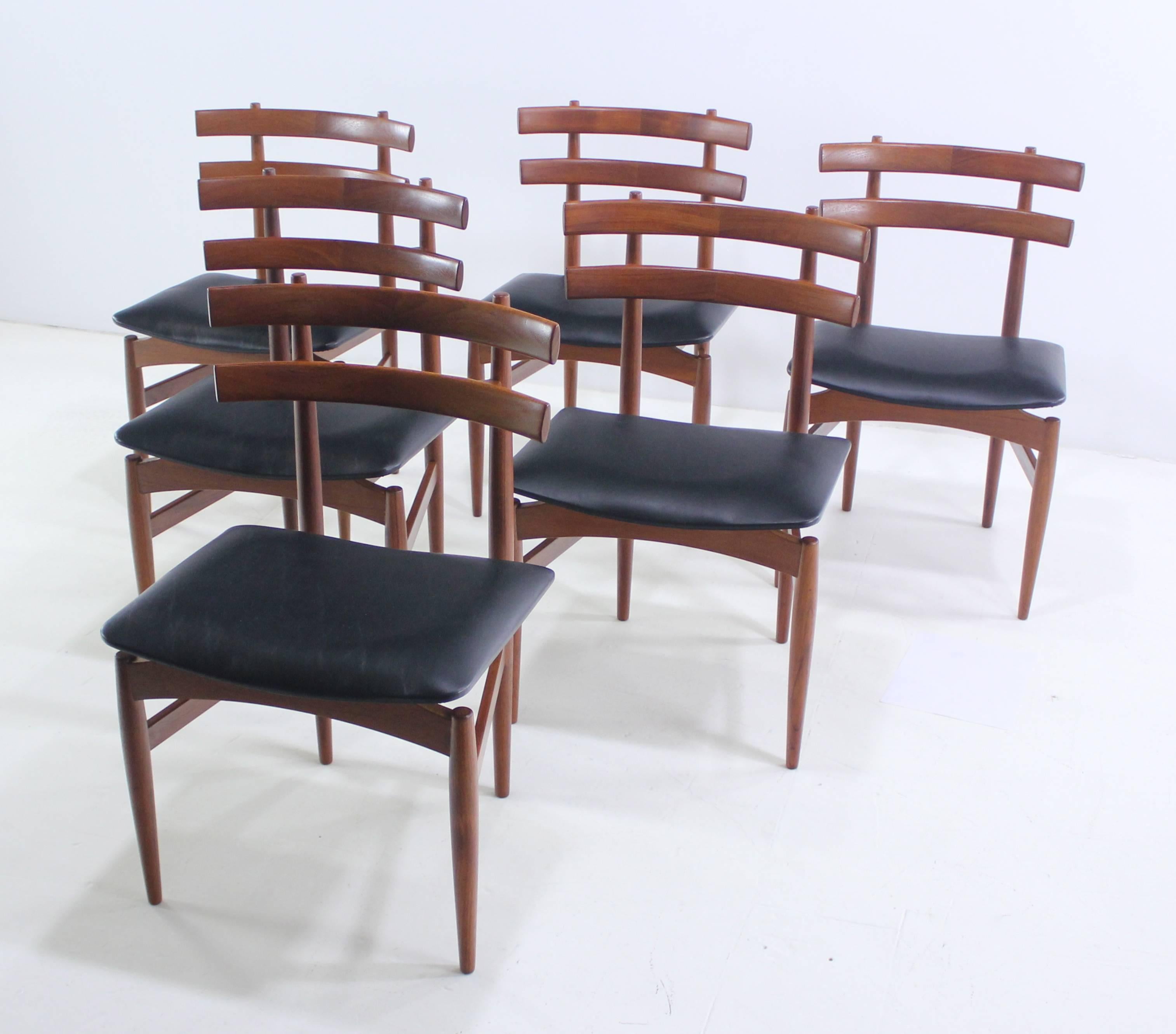 Six Danish modern chairs designed by Poul Hundevad. Model #30.
Rich teak frames with beautifully sculptured and joined ladder backs.
Distinctive in style, craftsmanship and quality.
Floating seats newly upholstered in highest quality black