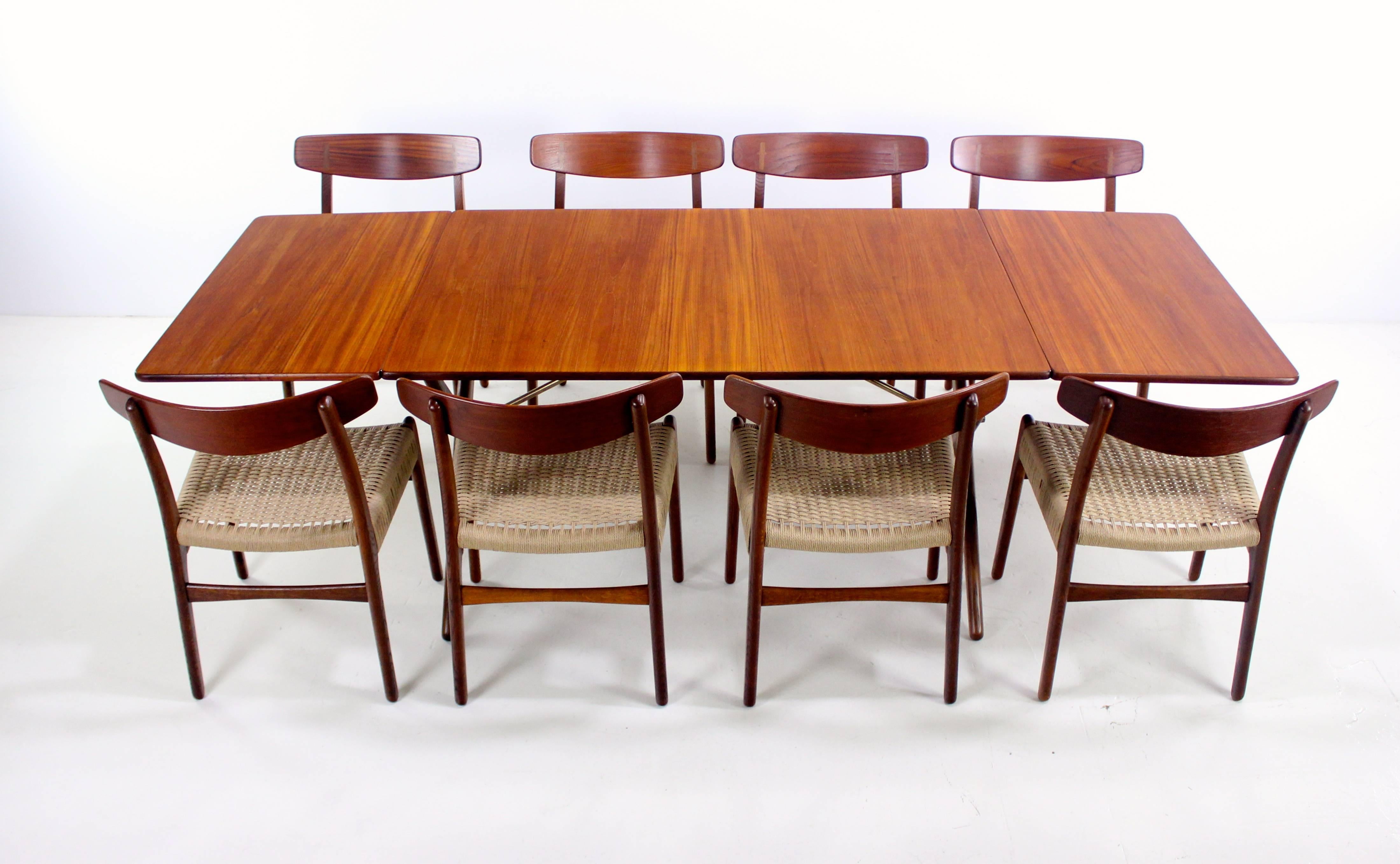 Danish modern dining set designed by Hans Wegner, circa 1950s.
Andreas Tuck, table maker.
Drop leaf table with richly grained teak top, beautifully styled oak legs and brass hardware.
Table measures 52