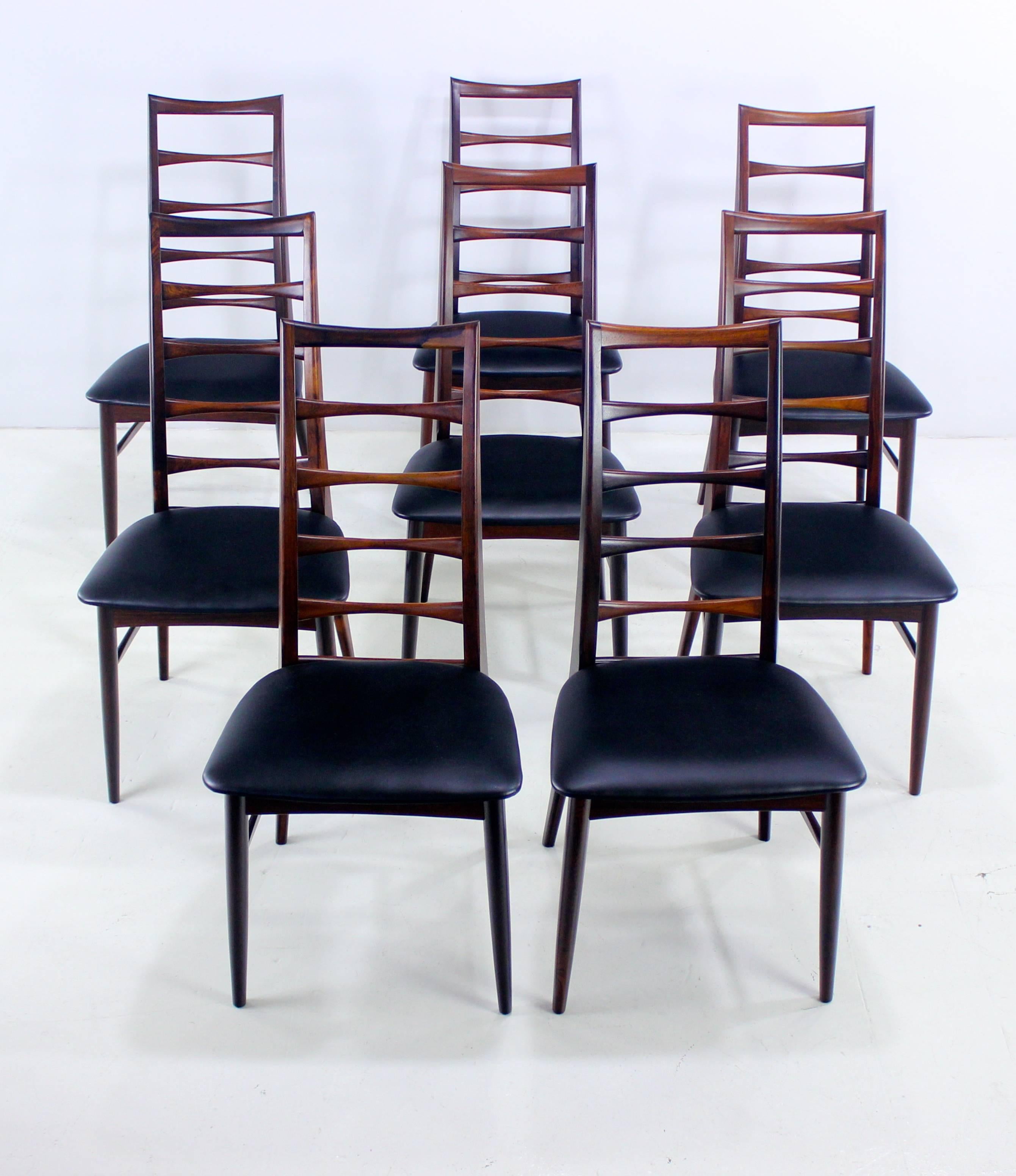 Eight Danish modern "Liz" dining chairs designed by Niels Koefoed.
Koefoeds Hornslett, maker.
Rich rosewood with elegant, tall ladder backs.
Newly upholstered in highest quality black leatherette.
Professionally restored and refinished