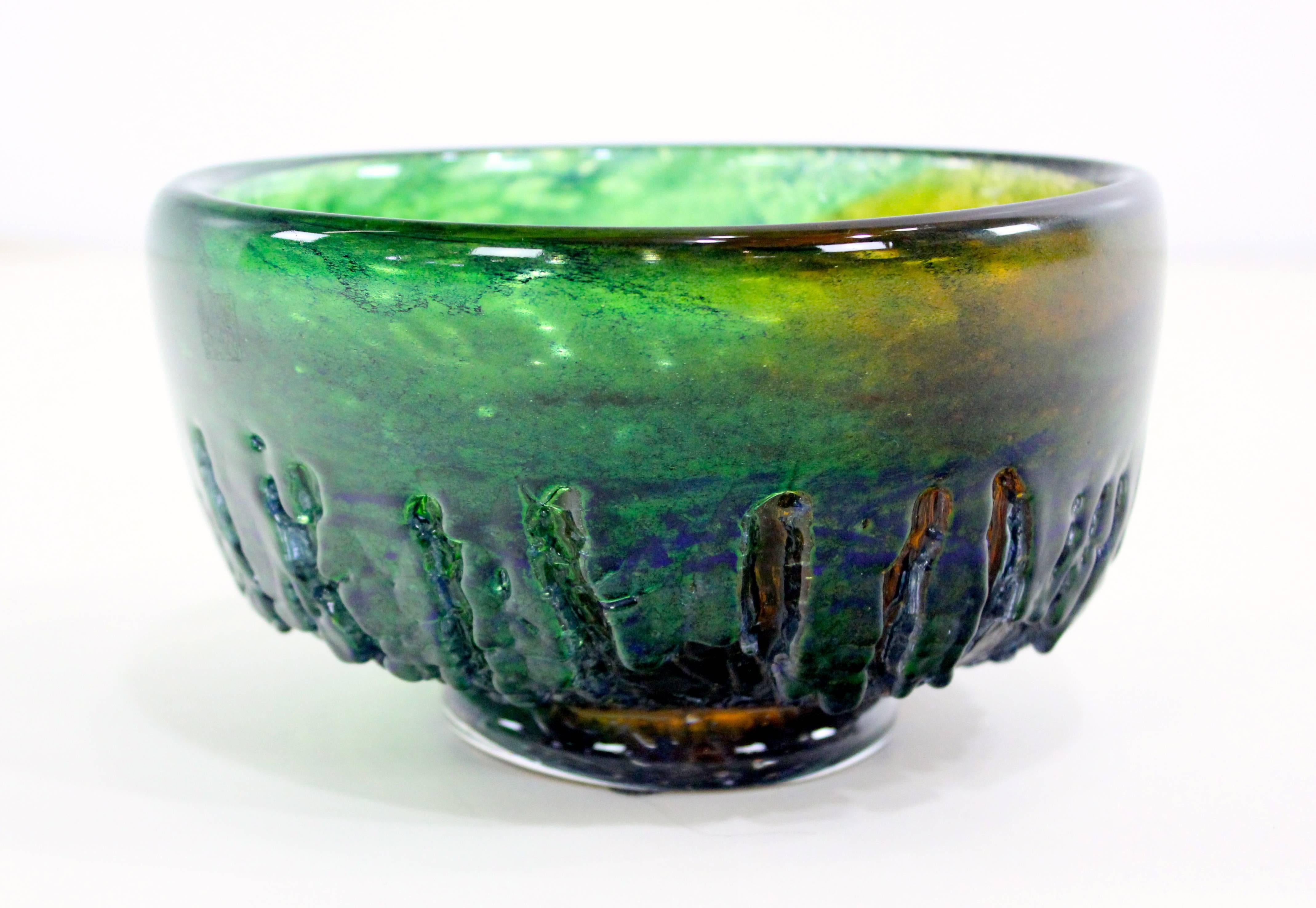 Scandinavian Modern art glass bowl by Goran Warff for Kosta.
1960s studio piece.
Bold, bleeding saturated colors.
Hand formed and inscribed with molten texture.
Matchless quality and price.
Low freight and quick ship.