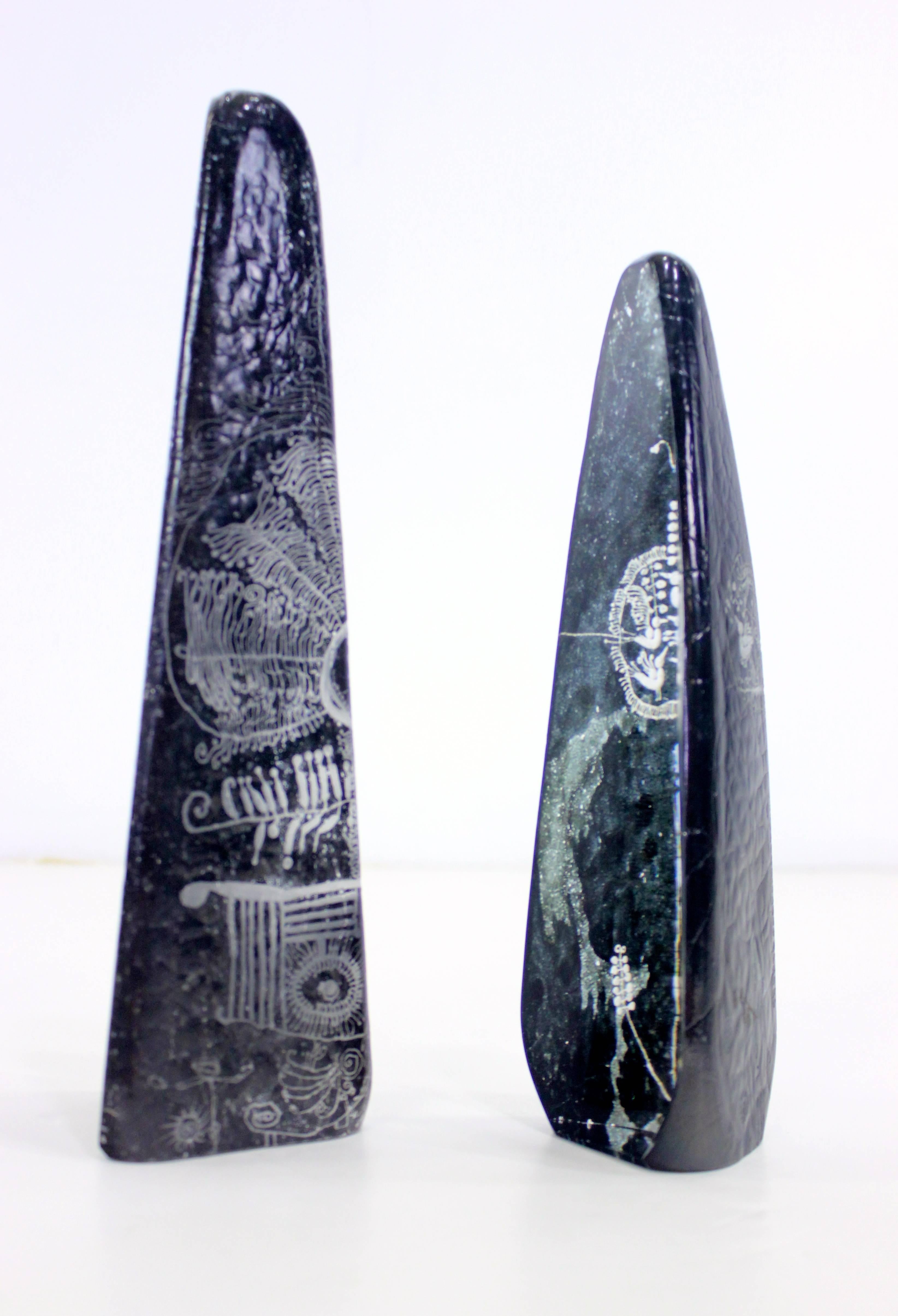 Two black art glass obelisks by Goran Warff for Kosta.
Hand formed and inscribed with delicate hieroglyphic-like etchings.
Small obelisk base measures 3 inches; height 10.25 inches.
Matchless quality and price.
Low freight and quick ship.

 