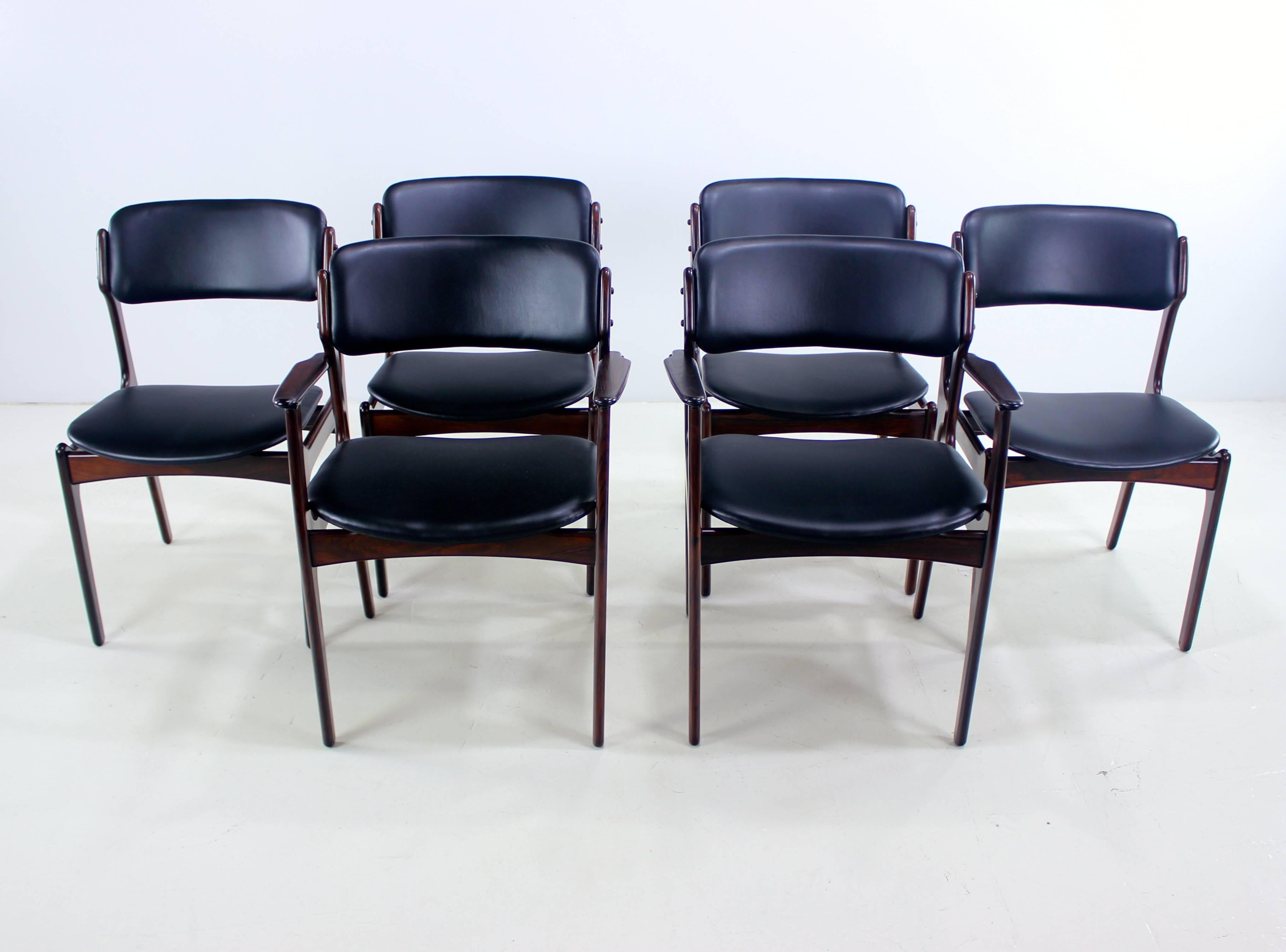 Six Danish modern dining chairs designed by Erik Buck. O.D Mobler A/S, maker.
Rich rosewood frames.
Floating seats and backs newly upholstered in highest quality black leatherette.
Superior comfort.
Includes two armchairs measuring 23.75" W