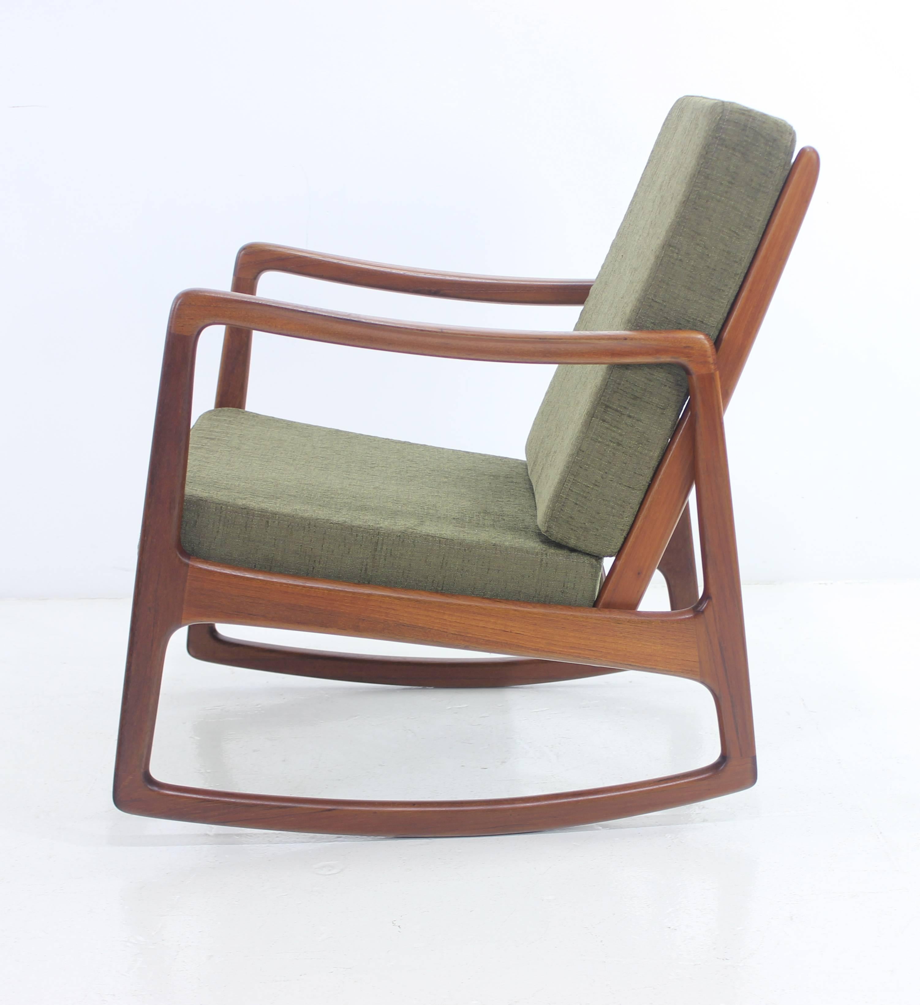Danish modern rocker designed by Ole Wanscher.
Imported by John Stuart.
Rich teak frame.
Cushions with new foam, newly upholstered in highest quality period fabric.
Professionally restored and refinished by LookModern.
Matchless quality and