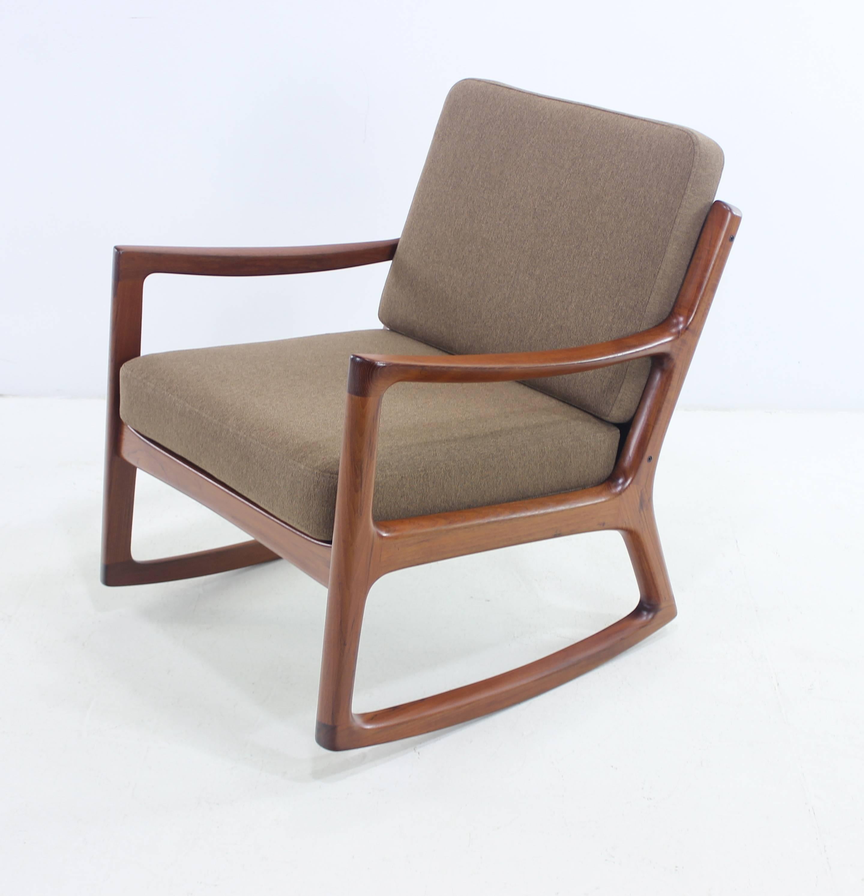 Danish modern rocker with heavier frame designed by Ole Wanscher.
Richly grained teak frame with elegant style and superior craftsmanship.
Original metal springs newly upholstered in highest quality period fabric.
Solid comfort and