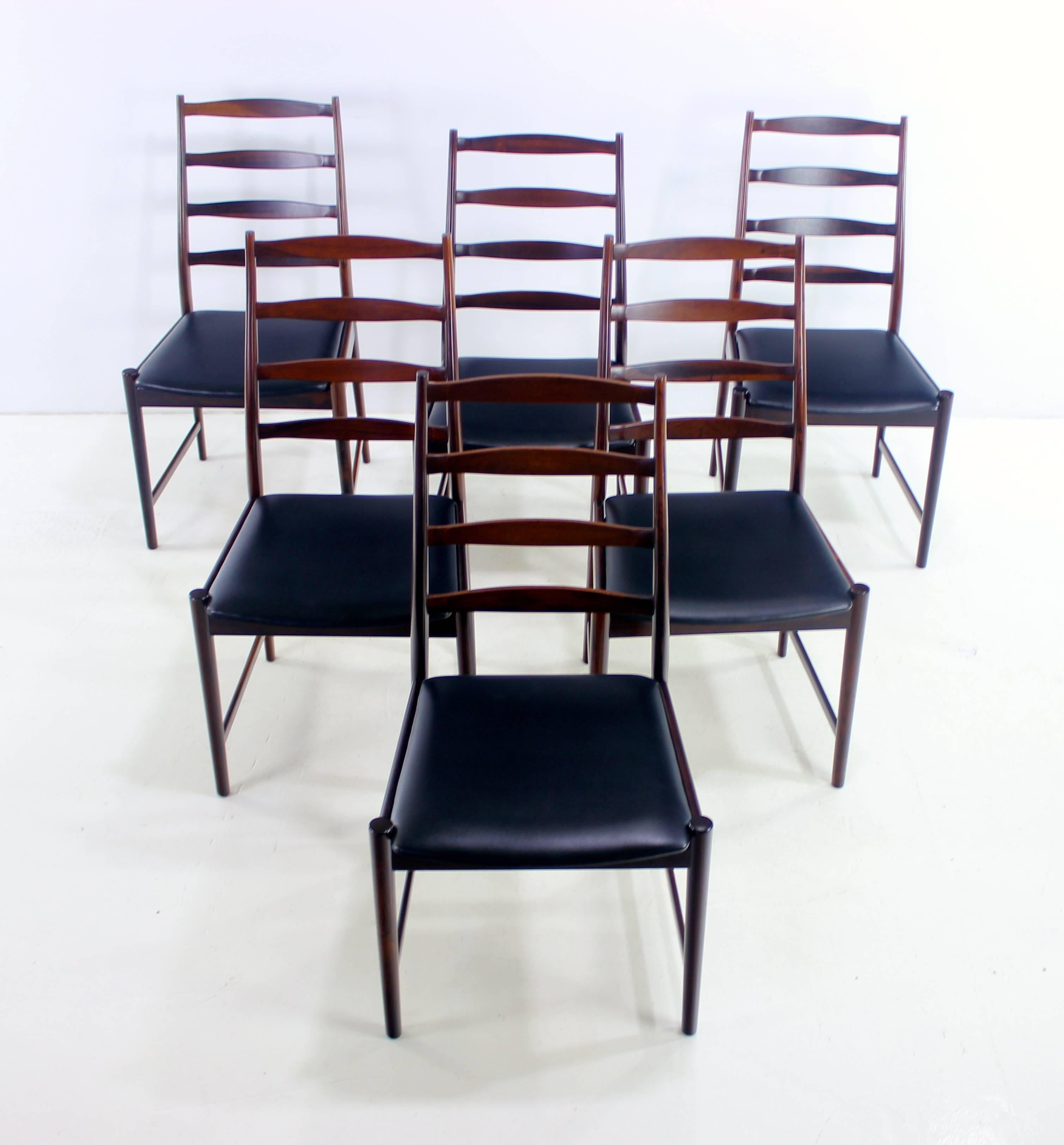 Six Danish modern ladder back dining chairs designed by Torbjørn Afdal.
Vamo Sonderborg, maker.
Rich rosewood frames with striking, sculptural style from every angle.
Original black upholstery.
Professionally restored and refinished by