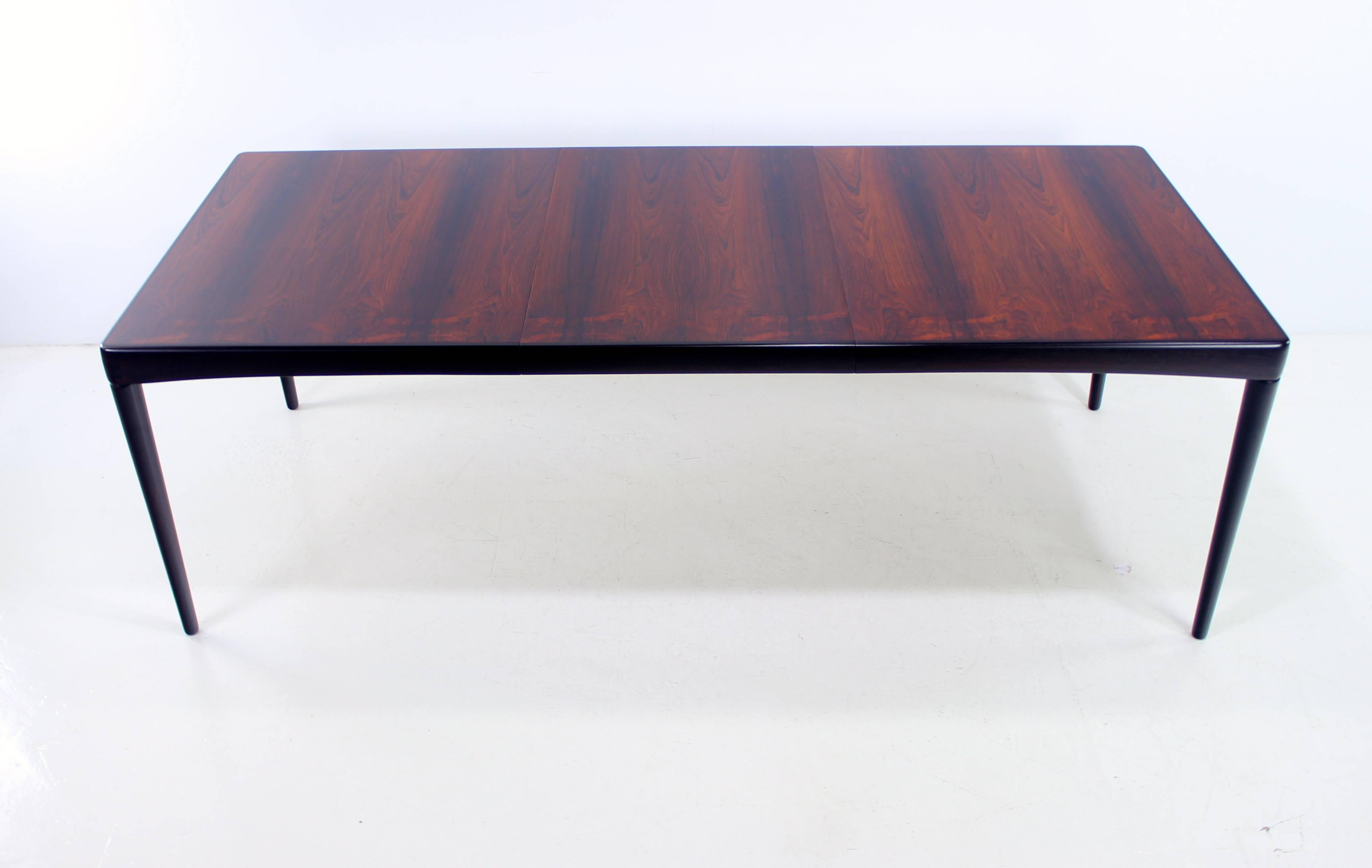 Danish modern dining table with one leaf designed in 1967 by H.W. Klein.
Bramin, maker.
Richly grained rosewood with inlaid wood on the corners.
Leaf measures 23.75" providing a full extension of 86.5".
Professionally restored and