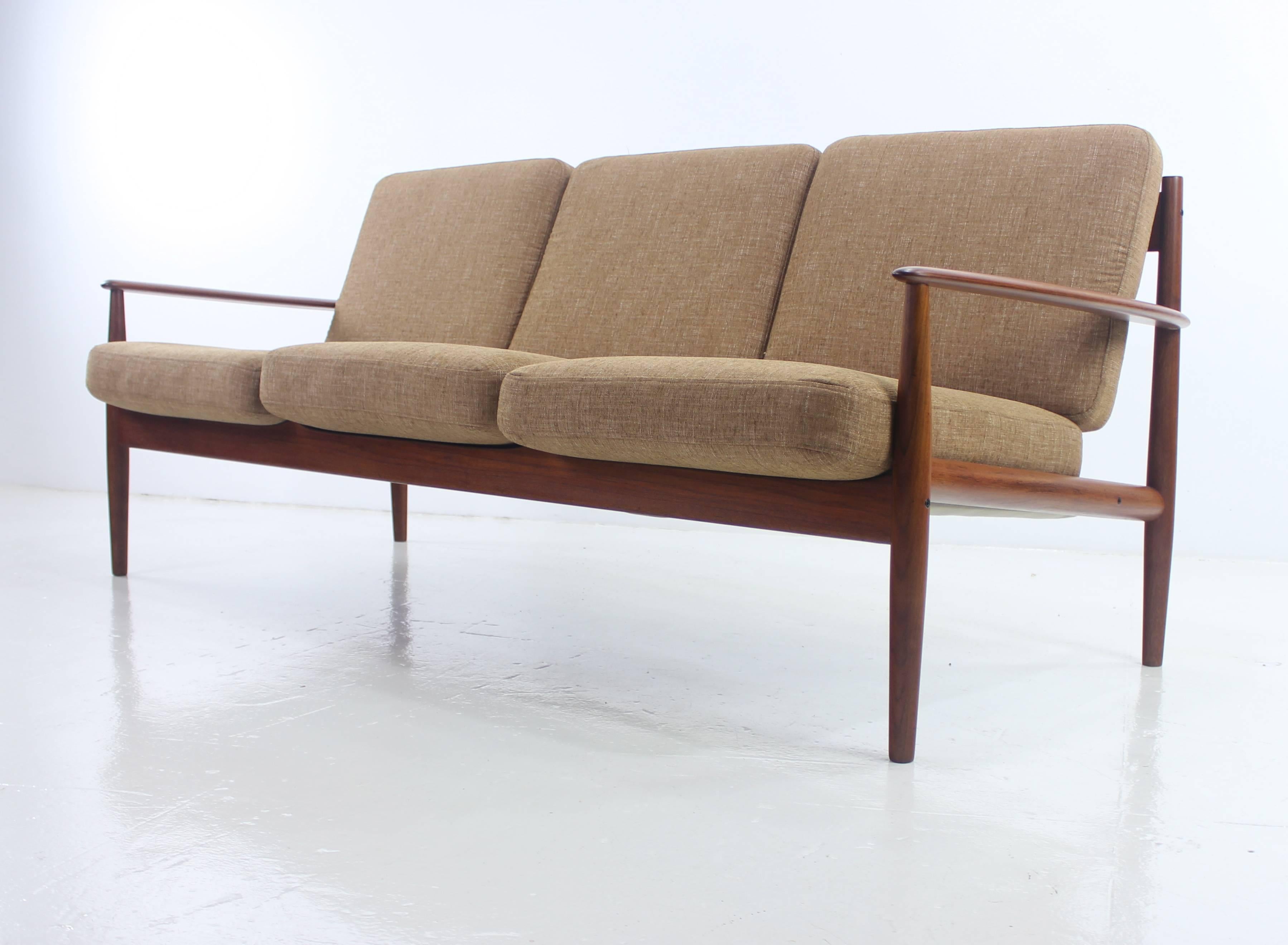 Danish modern three place sofa designed by Grete Jalk.
France & Son, importer.
Teak frame with beautiful style and craftsmanship from every angle.
Original metal inner cushions with new foam provide maximum comfort.
Six cushions newly