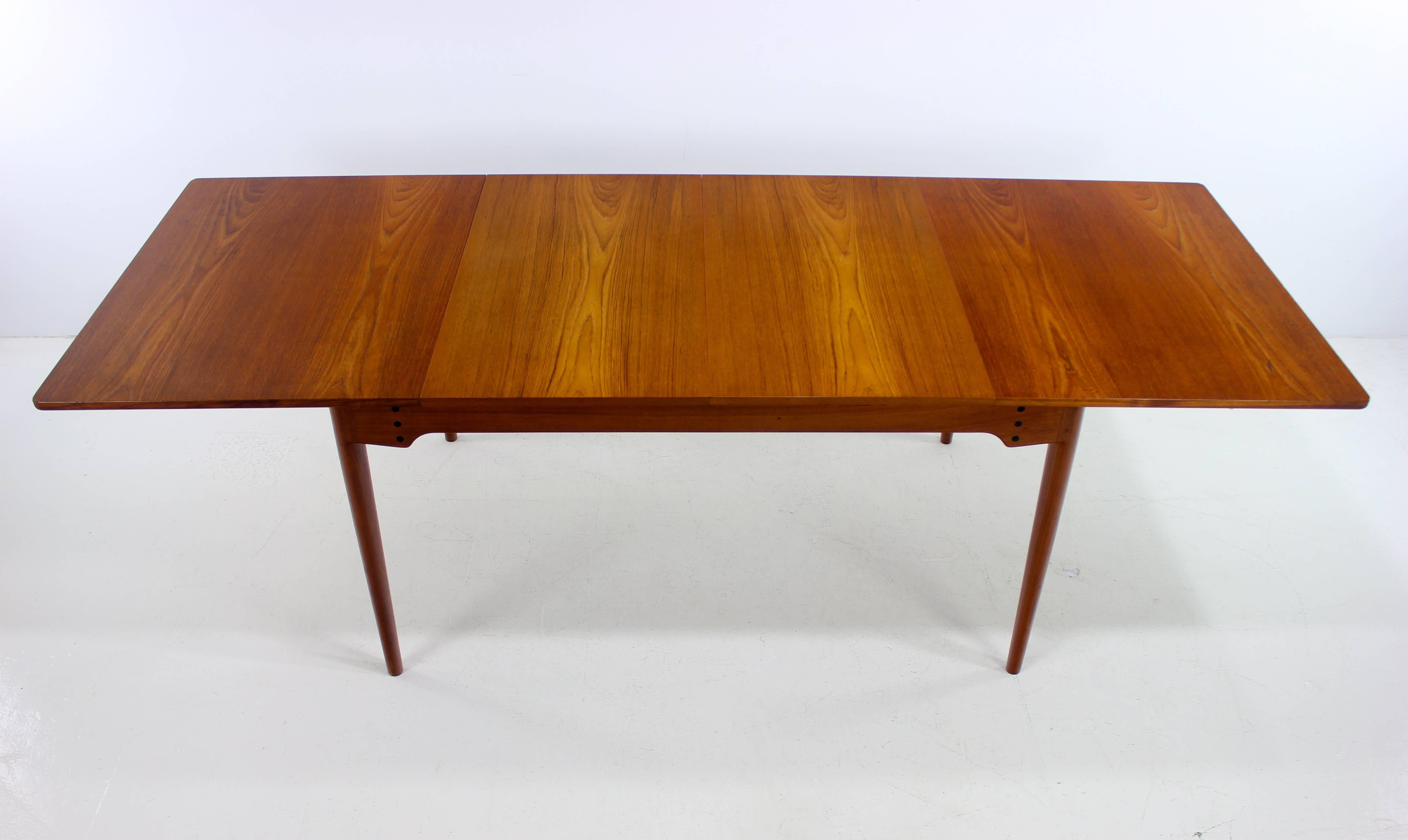Danish modern dining table designed by Finn Juhl.
Bovirke, maker, model # B065.
Richly grained teak with pure Scandinavian elegance and style.
Two leaves measure 19.75" providing a full extension of 94.75".
Matchless quality and
