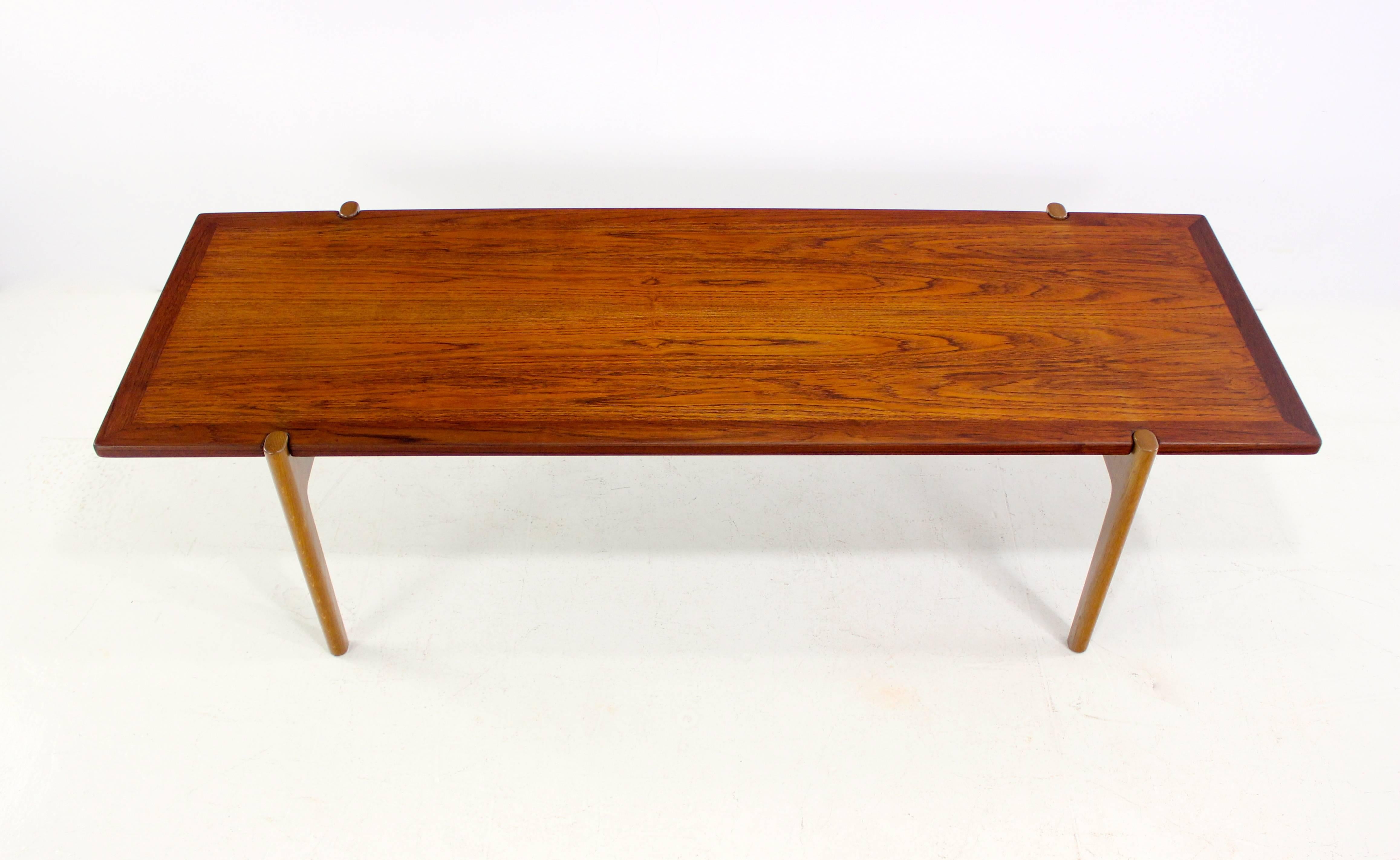 Danish modern coffee table designed by Hans Wegner.
Johannes Hansen, maker. Model JH 564.
Oak base with brass hardware.
Teak top with inlay on edge reverses to black laminate.
Professionally restored and refinished by LookModern.
Matchless