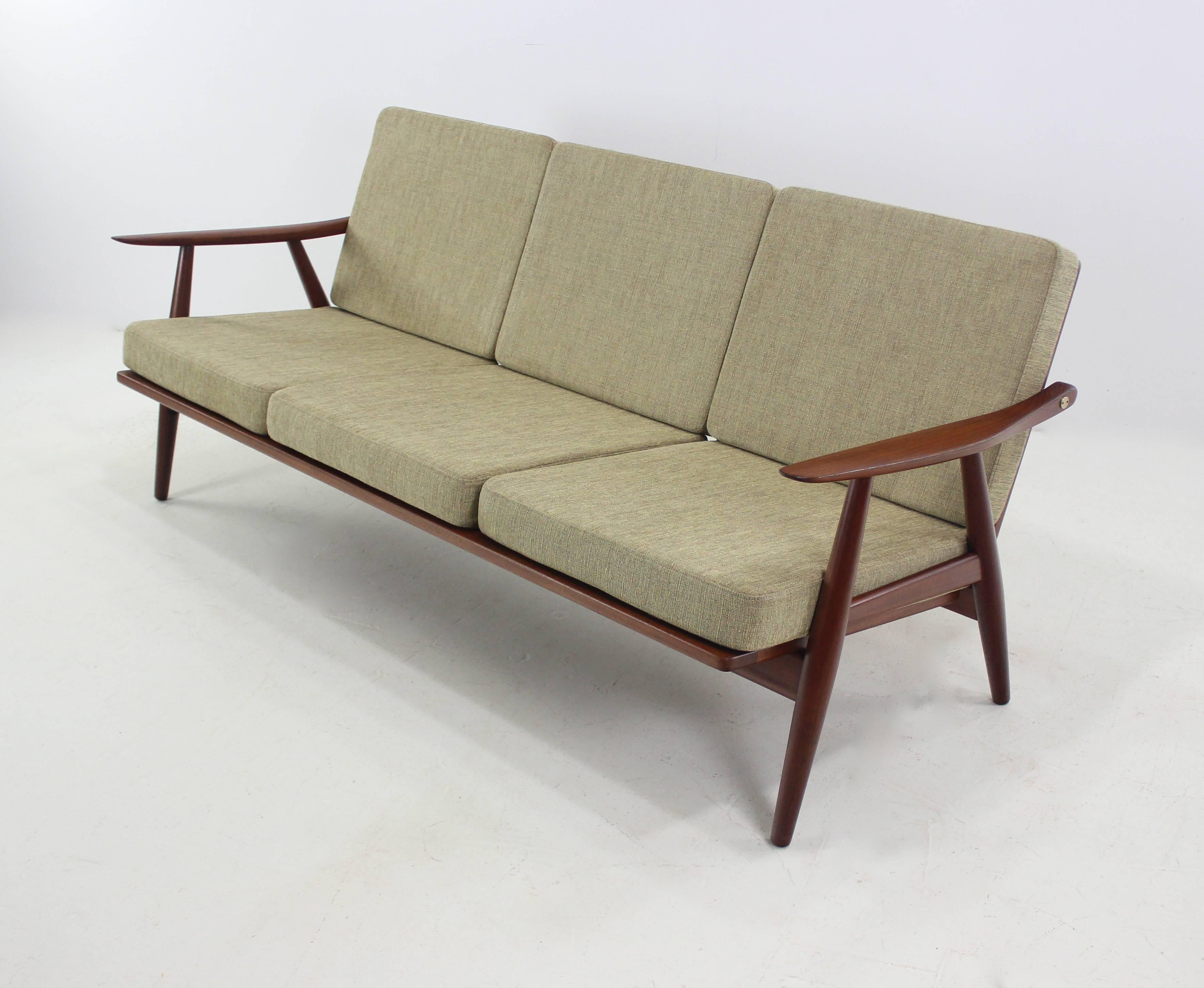 Rare Danish modern sofa designed by Hans Wegner, circa 1954.
GETAMA, maker.
Model #GE-70.
Teak frame with brass hardware.
Newly upholstered in highest quality period fabric.
Pair of matching chairs to be listed separately.
Professionally