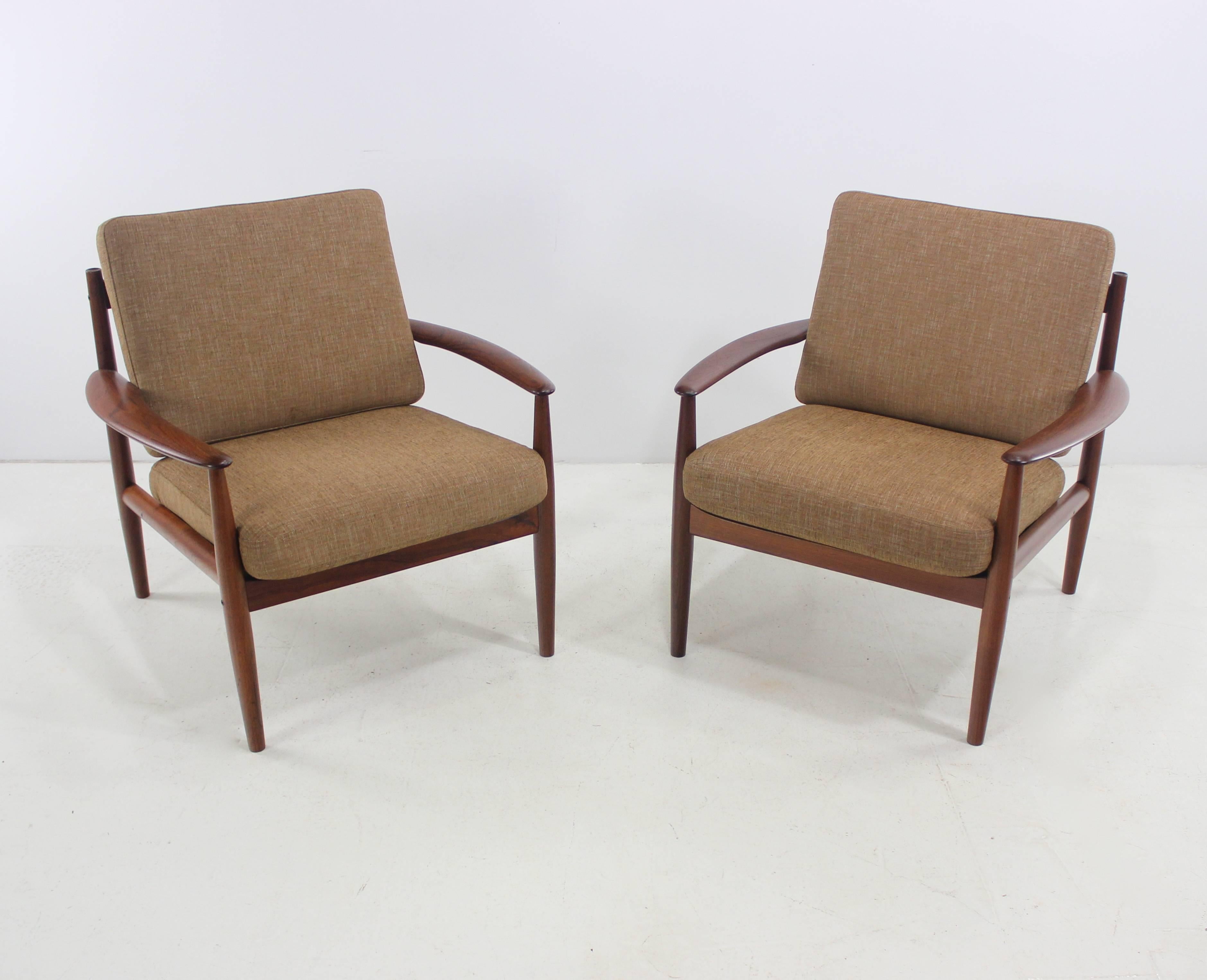 Two Danish modern armchairs designed by Grete Jalk. 
Late 1950s-1960s.
France & Son, makers.
Teak frames with beautifully sculptured wood slat backs and cable supports.
Cushions contain original metal innersprings wrapped in new foam and newly