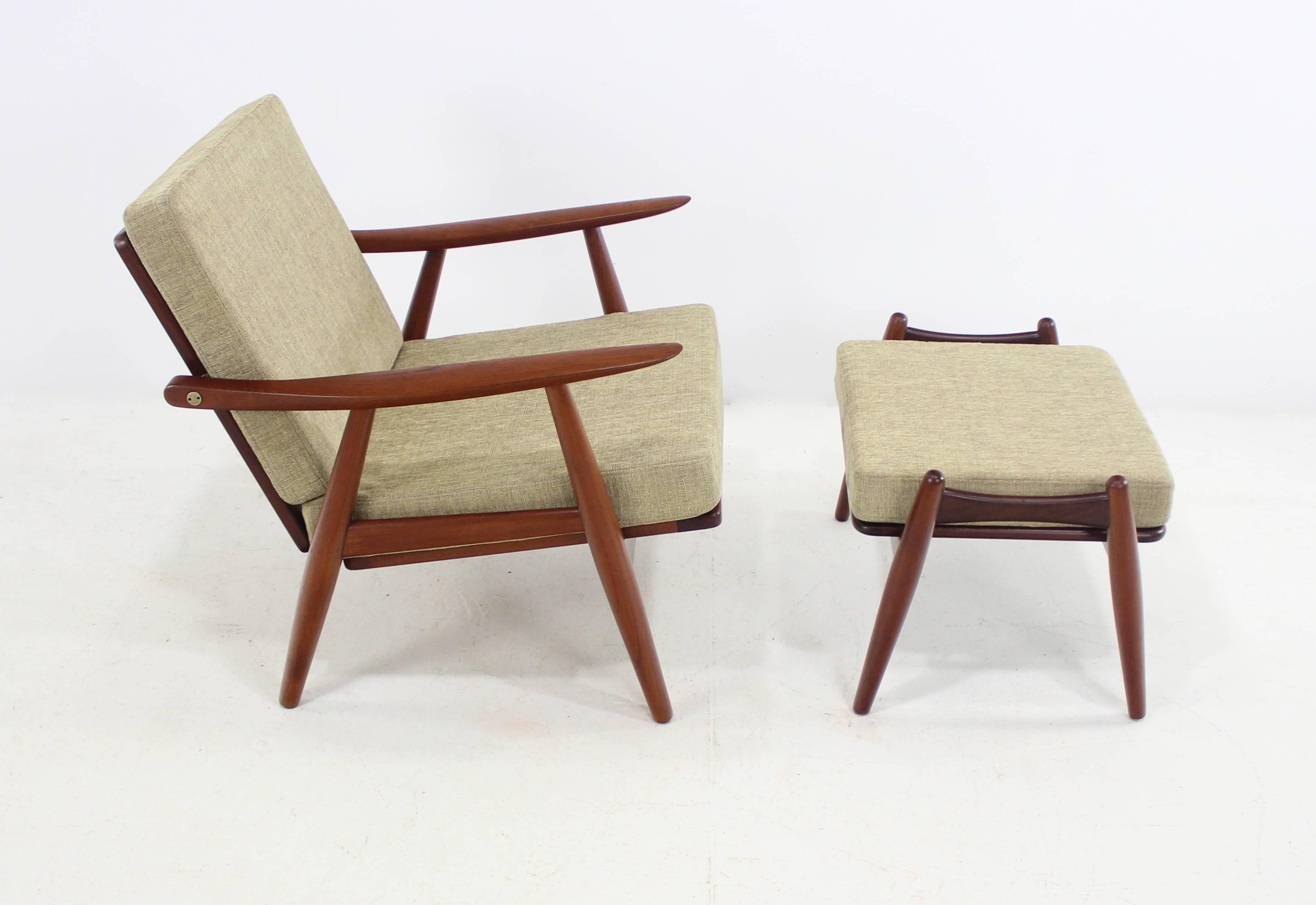 Two Danish modern armchairs and one ottoman designed by Hans Wegner.
GETAMA Getsted, maker. Model GE-70.
Teak frames with brass hardware.
Newly upholstered in highest quality period fabric.
Ottoman measures 15.5