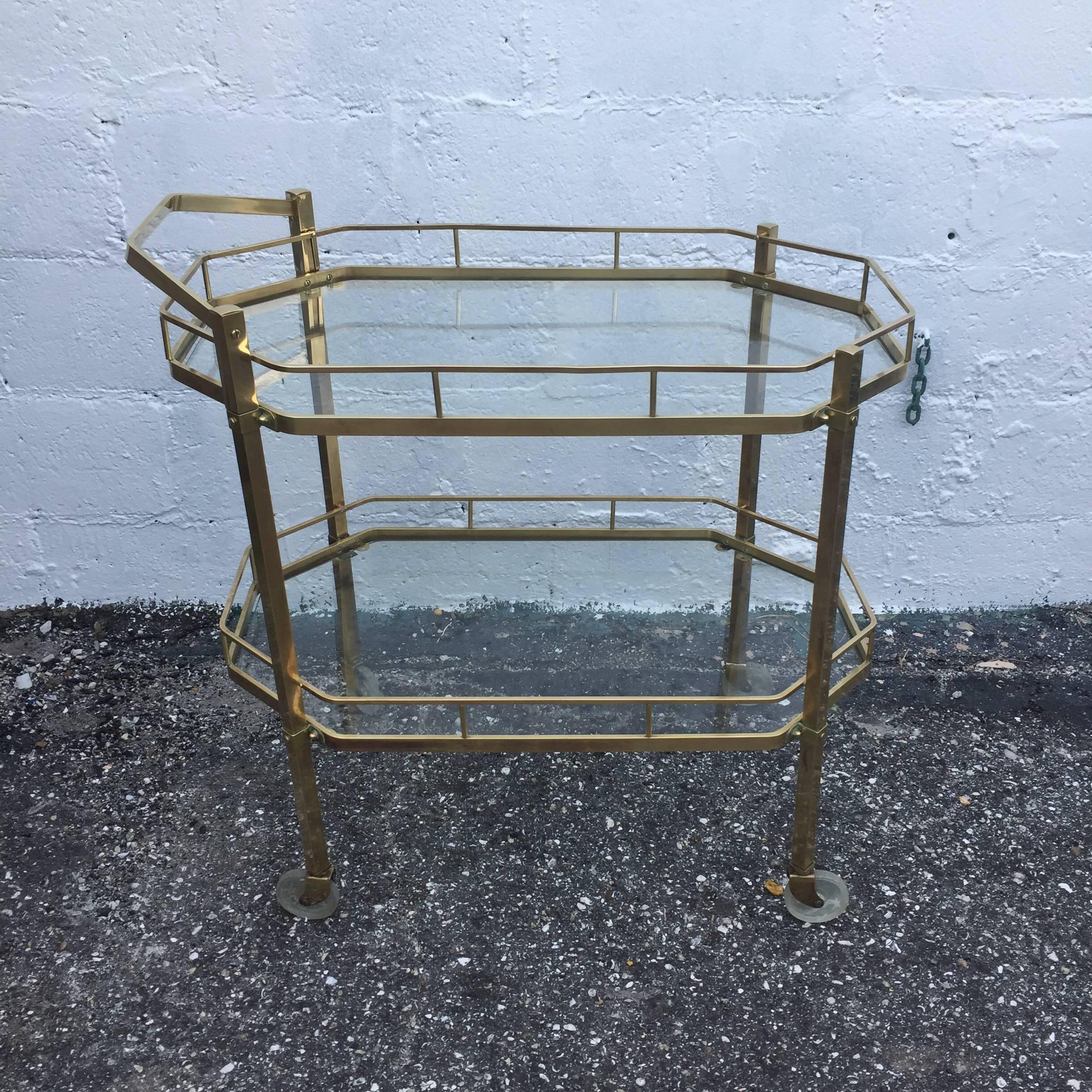 Polished brass and glass dessert, bar or tea cart on wheels from the mid-20th century.