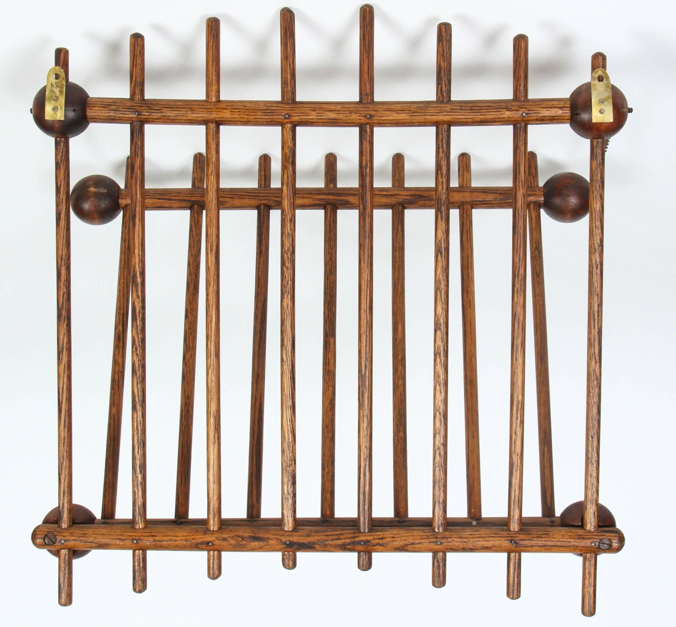 Vintage folding magazine wall rack with ball and chain detail.
  