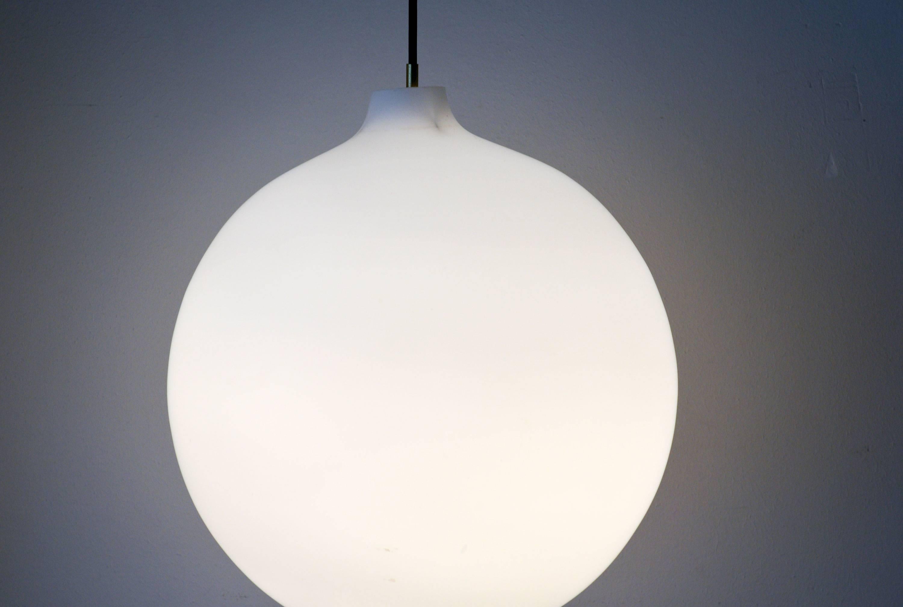 Satellite lamp by Vilhelm Wohlert for Louis Poulsen,
Denmark, 1950.
This is the vintage big version with a diameter of 40 by 42 cm.
White glass ball with an elegant brass stem that holds the socket and conceals the wire.
The glass shade gives an