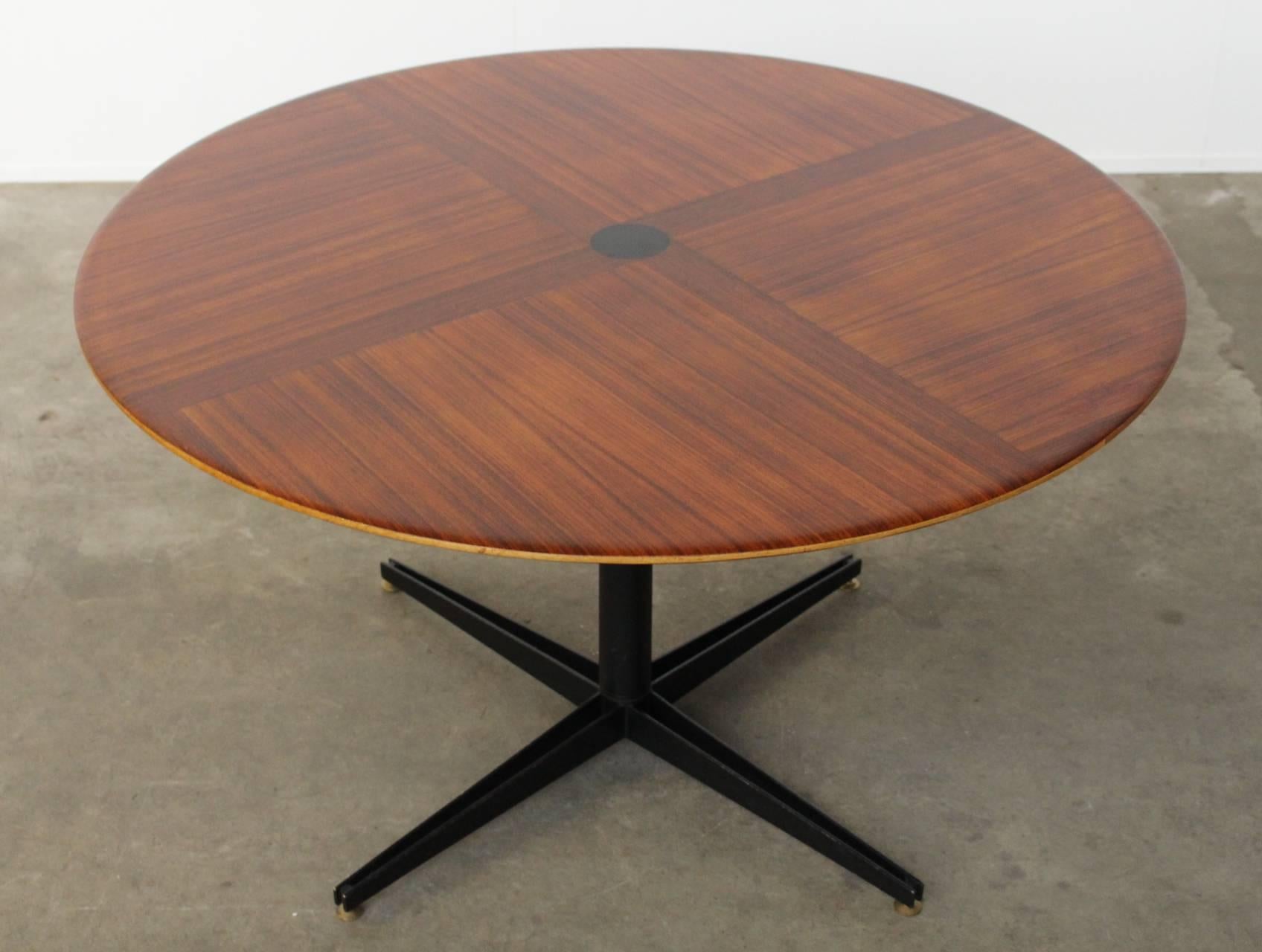Rare adjustable table T41 by Italian designer Osvaldo Borsani for Tecno with an enamelled steel base and rosewood top with the distinctive large coromandel dot in the center. The table can be lowered by means of the steel bar underneath the top that