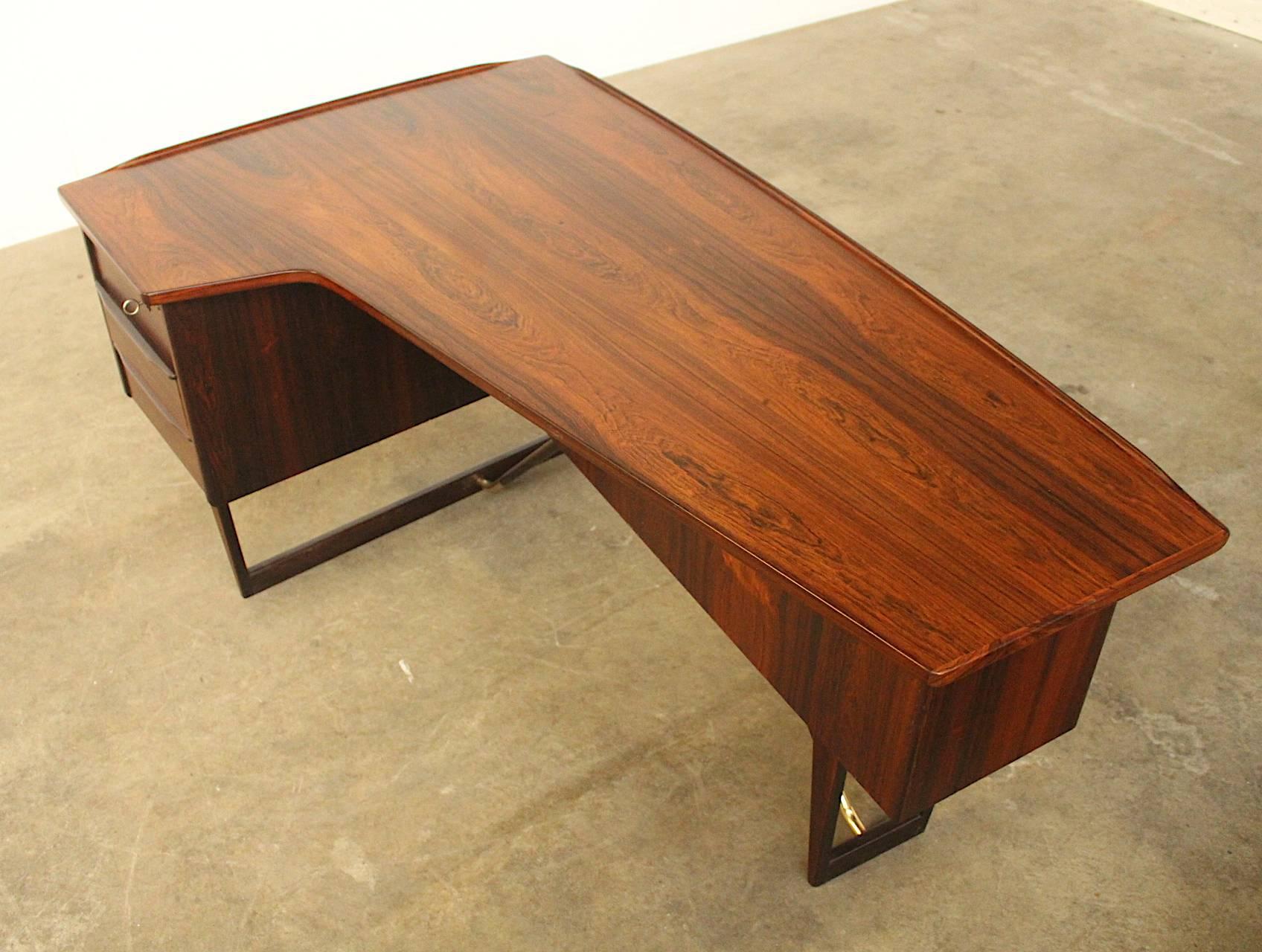 For all items from this dealer please hit the button VIEW ALL FROM SELLER below on this page

Beautifully shaped rosewood corner desk by Peter Lovig. The desk has three drawers of which the top drawer is fitted with a lock, a wide bookshelf in the