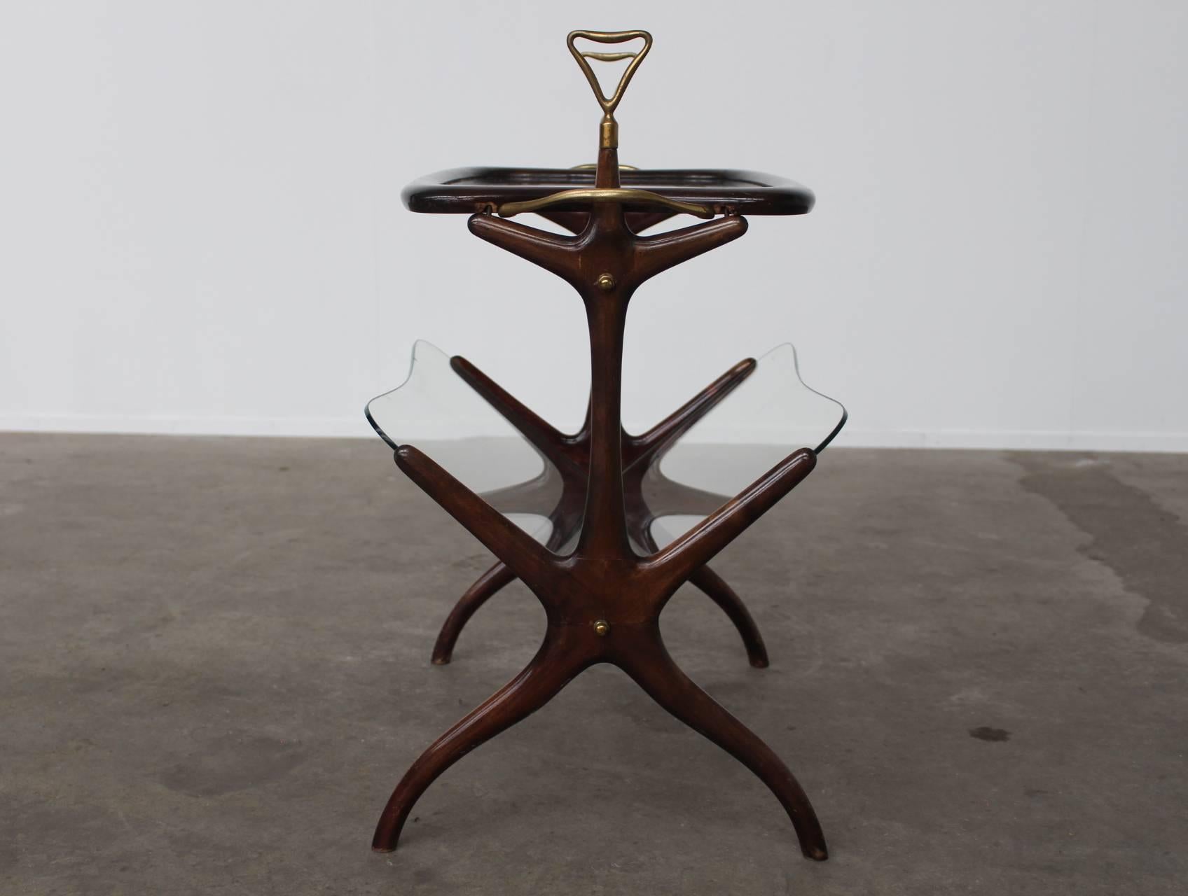 Beautiful organic shaped multi-functional side table.
This table can be used as a magazine rack on the lower level, but also has the function of a serving tray / table.
The top with brass handles is removable and then becomes an elegant tray to