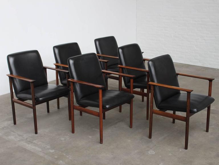 Set of 6 large conference or dining chairs designed by Arne Vodder for Sibast Furniture Denmark, 1960s.
The chairs are made out of top quality solid Brazilian rosewood and upholstered with black leatherette.
All chairs are in a very good
