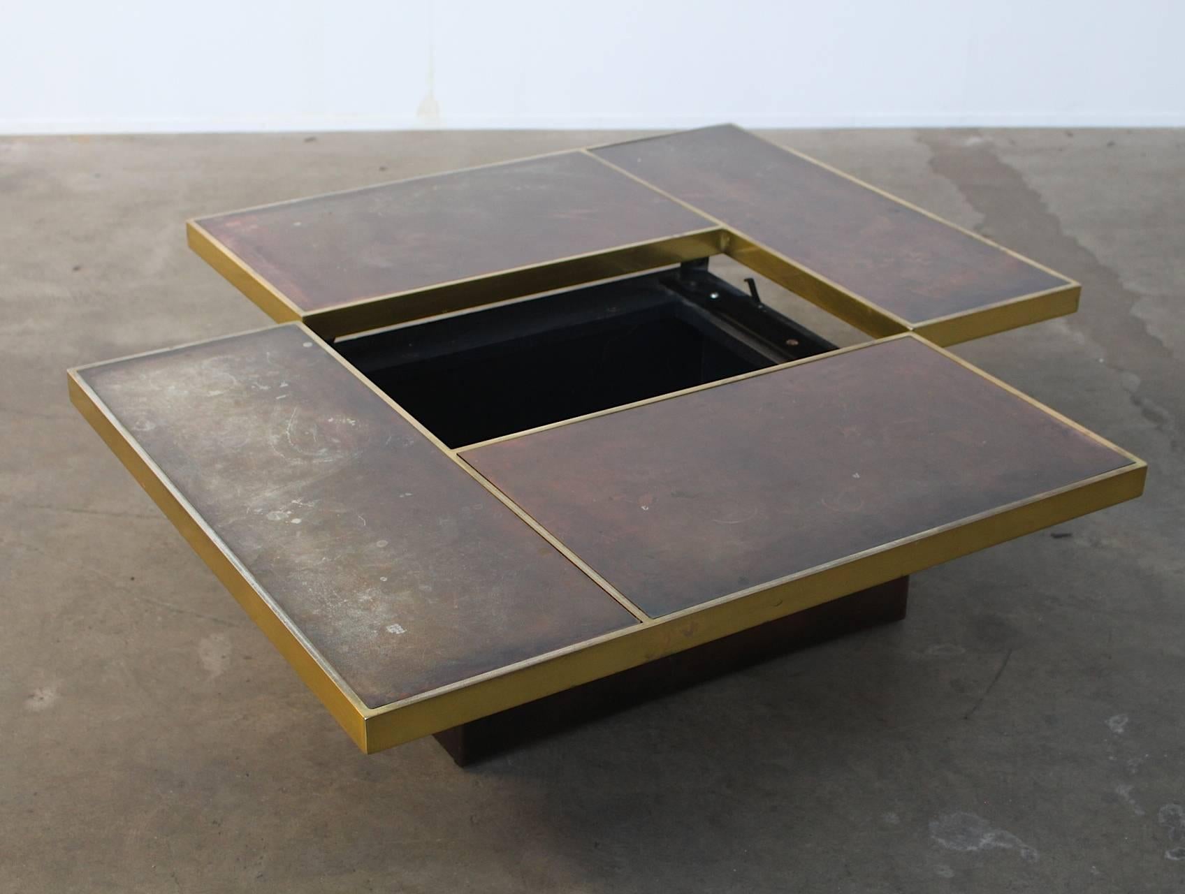 Stunning geometric Italian cocktail table, 1970’s. 
Brass framing and red etched copper top and base. The top can slide open and hides a mirrored bar. This chique eye-catching coffee table with incorporated dry bar fits perfectly in a Willy Rizzo
