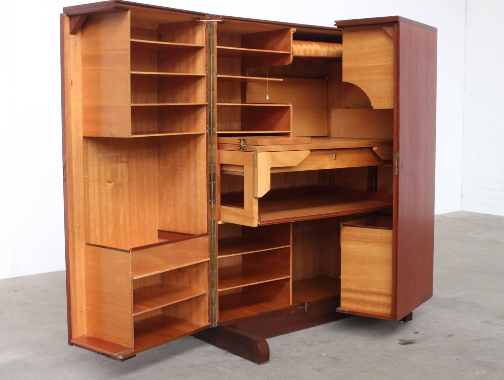 Amazing completely (un)foldable multi functional desk secretary with countless retractable shelves, drawers and boxes and a build-in light over the desk top. This is a unique and rare to find piece nick-named the 