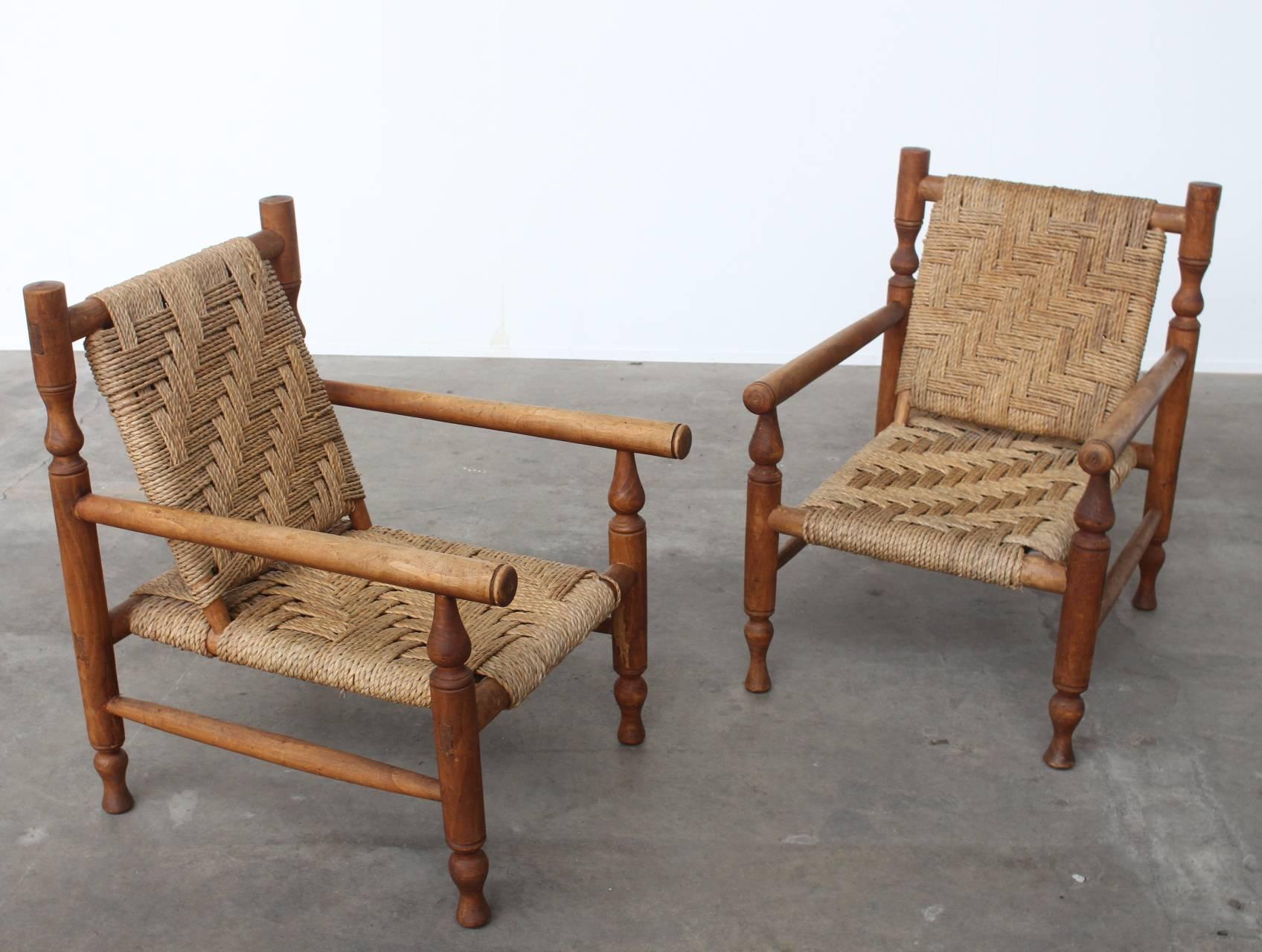 Pair of French lounge chairs in the style of Charlotte Perriand.
The frame of the chairs are build out of ash wood and come with a woven sisal rope seat and backrest.
The chairs do have a craftsmanship structure and are beautiful