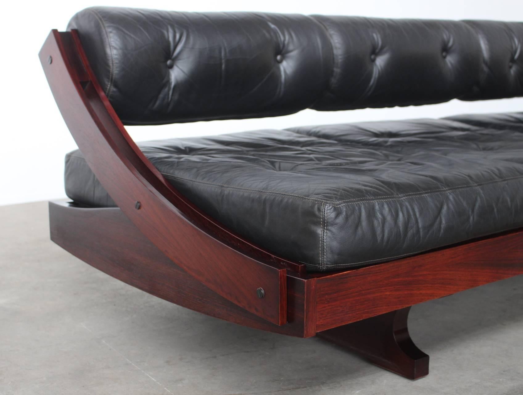 Rare multifunctional sofa model GS-195 designed in 1963 by Gianni Songia and manufactured by Sormani in Arosio, Italy. The sofa has a Brazilian rosewood frame that holds three tufted black leather cushions in perfect condition. The backrest slides