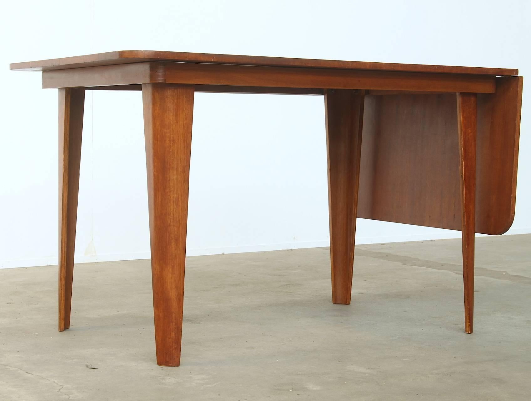 Very rare extendable dining table by Cor Alons for Dutch furniture factory Gouda den Boer, circa 1949.
The table is made of beautifully shaped tanned laminated wood (plywood) and accommodates six people easily. The table is part of a dining set of