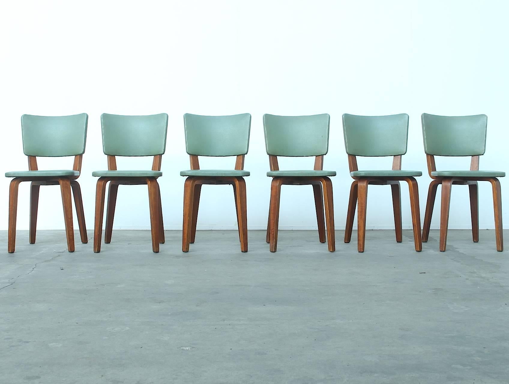 Beautiful early mid-century Dutch design dining chairs by Cor Alons manufactured by furniture factory Gouda Den Boer Holland, circa 1949.
The chairs are made of laminated birchwood and are upholstered in amazing color green leatherette, which is