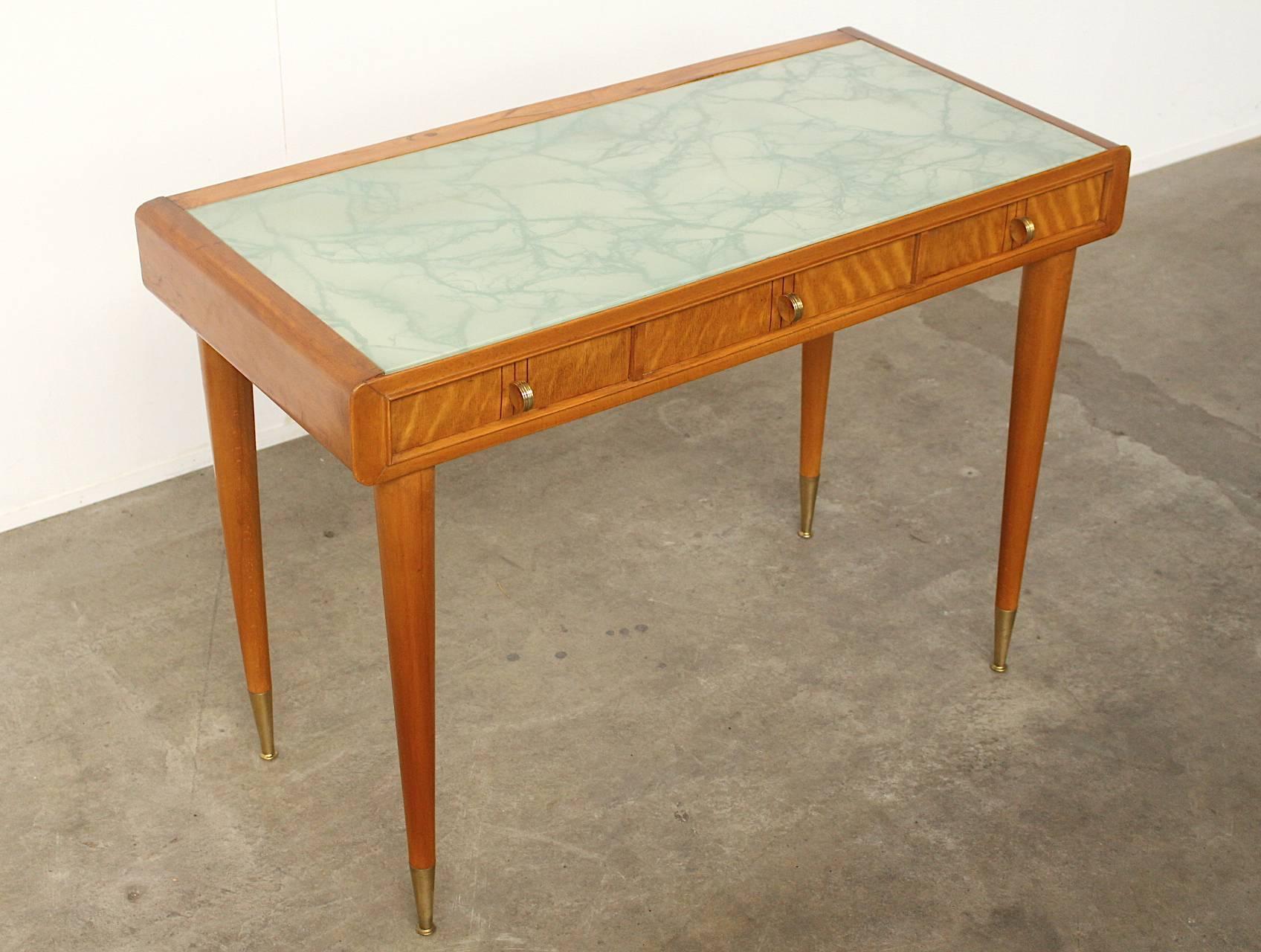 Very exquisite and beautifully crafted pear wood console, lady desk or writing desk by Carlo de Carli. Three drawers fitted with copper handles, copper leg ends and a very beautiful writing-top inlay of milky white and blue veined art glass.