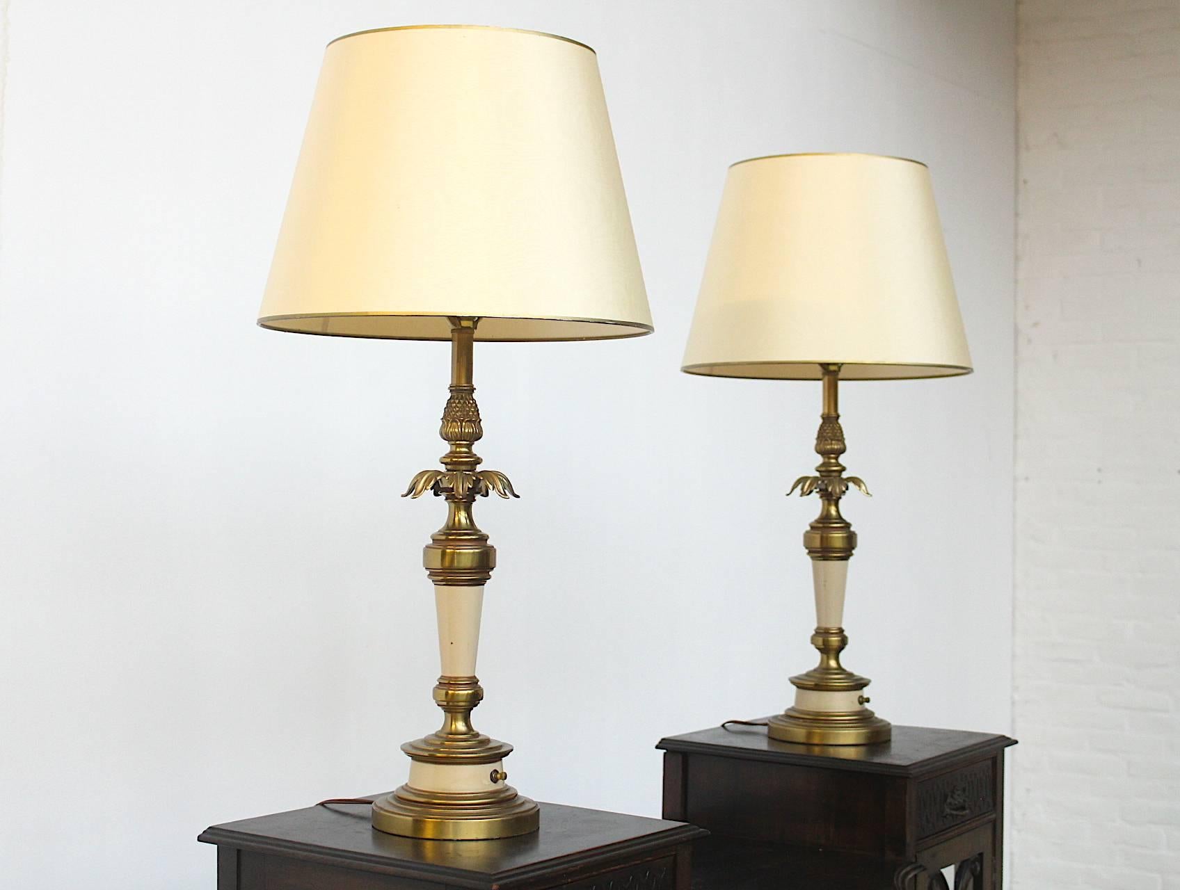 Beautiful metal and copper set of two identical Hollywood Regency style table lamps made circa 1960 by the Stiffel lighting company in Chicago, IL.
These two lamps have their original shades in excellent condition, please note that these lights are