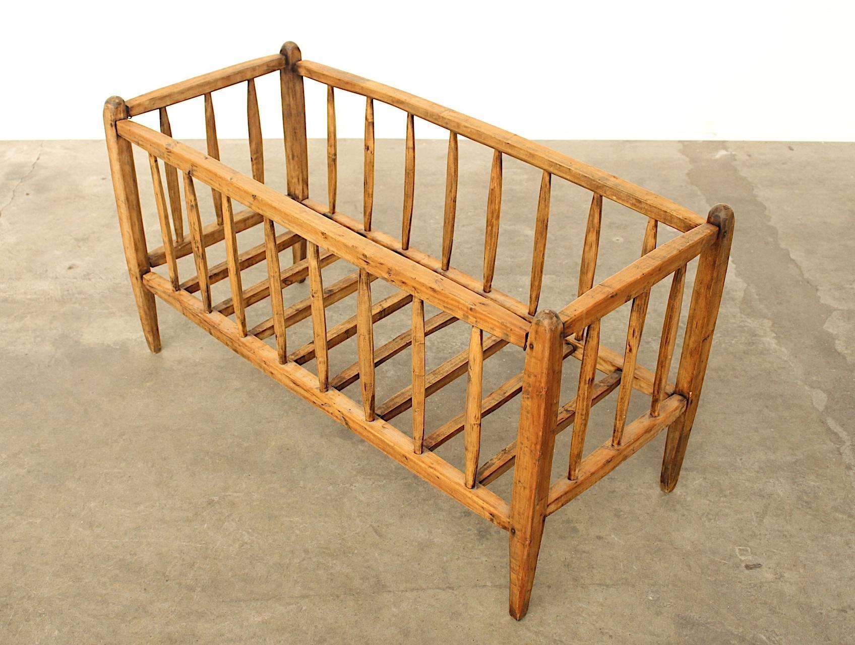 Beautifully hand carved and crafted arts and craft style or shaker style antique baby bed or cradle. No nails or screws are used, only wood joints. This is a highly decorative and sculptural item that can be used where it's made for or to be placed