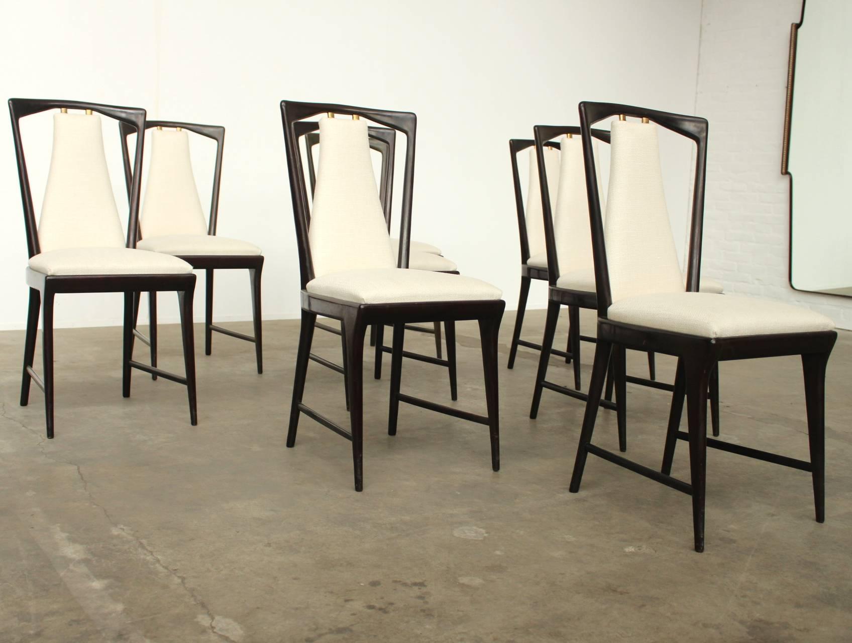 Wonderful set of eight very elegant, newly upholstered unused mahogany dining chairs with copper details. The new foam and fabric is of superior quality, the upholstery has a subtle small fish bone pattern and shiny silk-like threads woven through