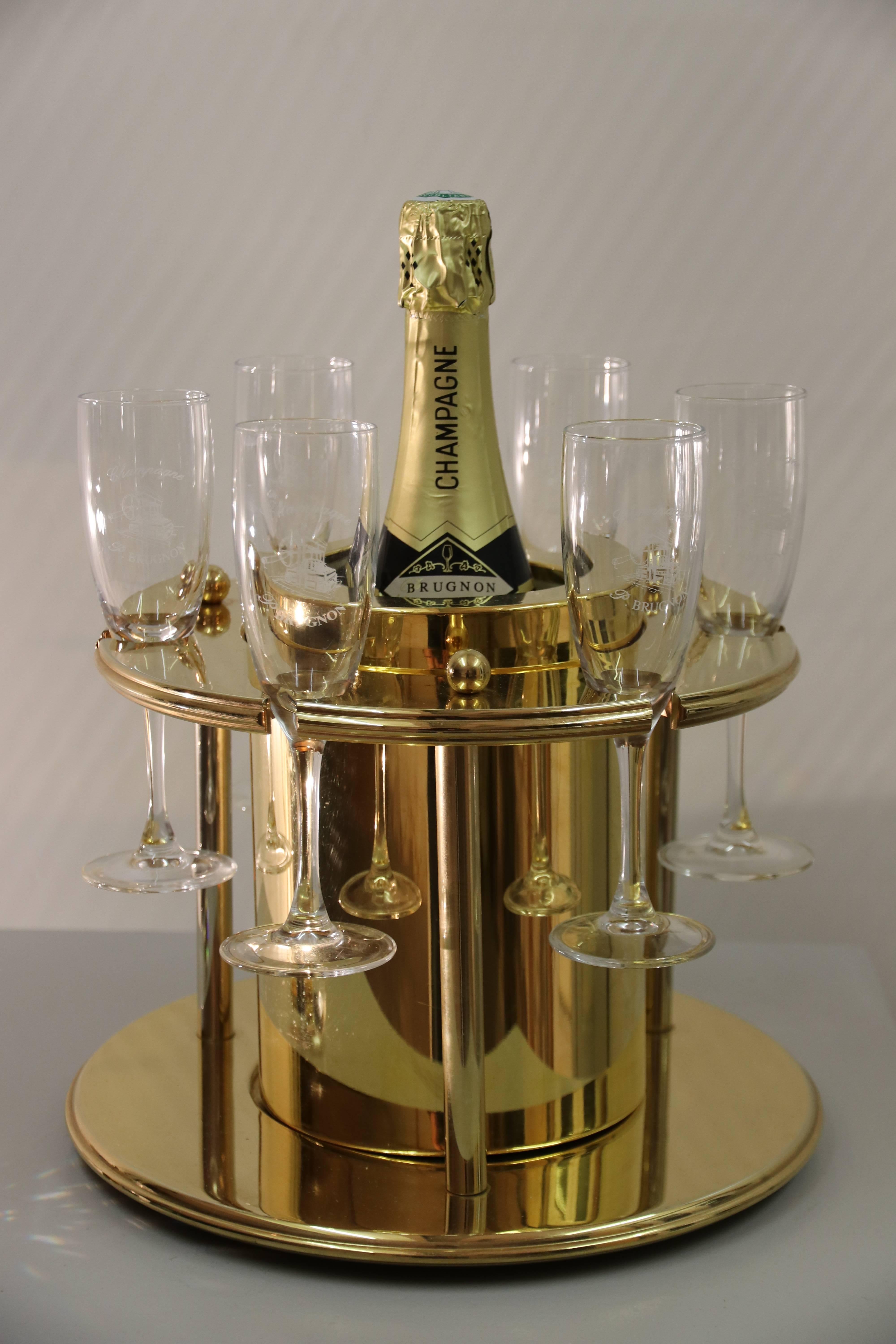Rare piece from the Turnwald Collection - Switzerland. This is a 23 carat gold plated plastic Champagne bottle cooler with 4 inside cooling elements and room to place 6 champagne glasses around the cooler. Comes with the original chrystal bottle