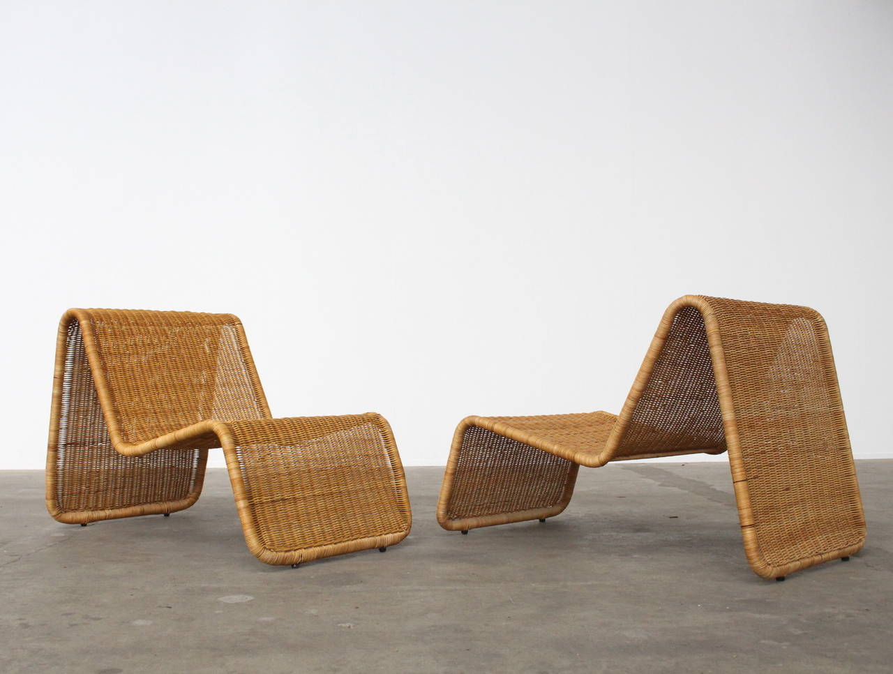 For all items from this dealer please hit the button VIEW ALL FROM SELLER below on this page

Wonderful pair of sculptural lounge chairs designed by Tito Agnoli for Bonacina. Tubular lacquered steel frame with woven wicker. This model can be used