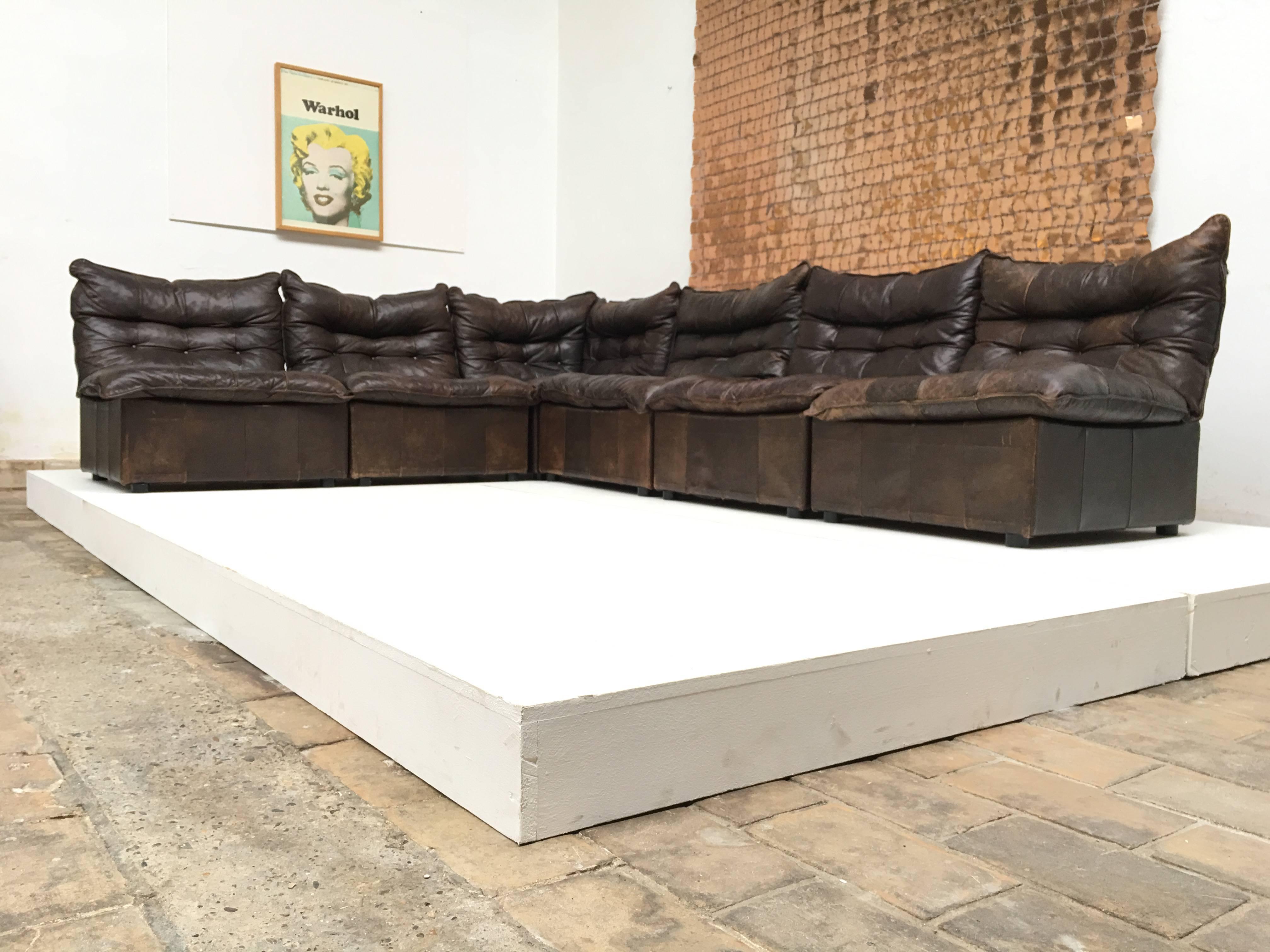 Gypset style distressed chocolate brown leather sectional sofa with wood and canvas details in the backrest.

The quality of this sectional sofa is like a Swiss Desede but this one is most likely to be produced by Leolux in the 1970s.
Leolux is