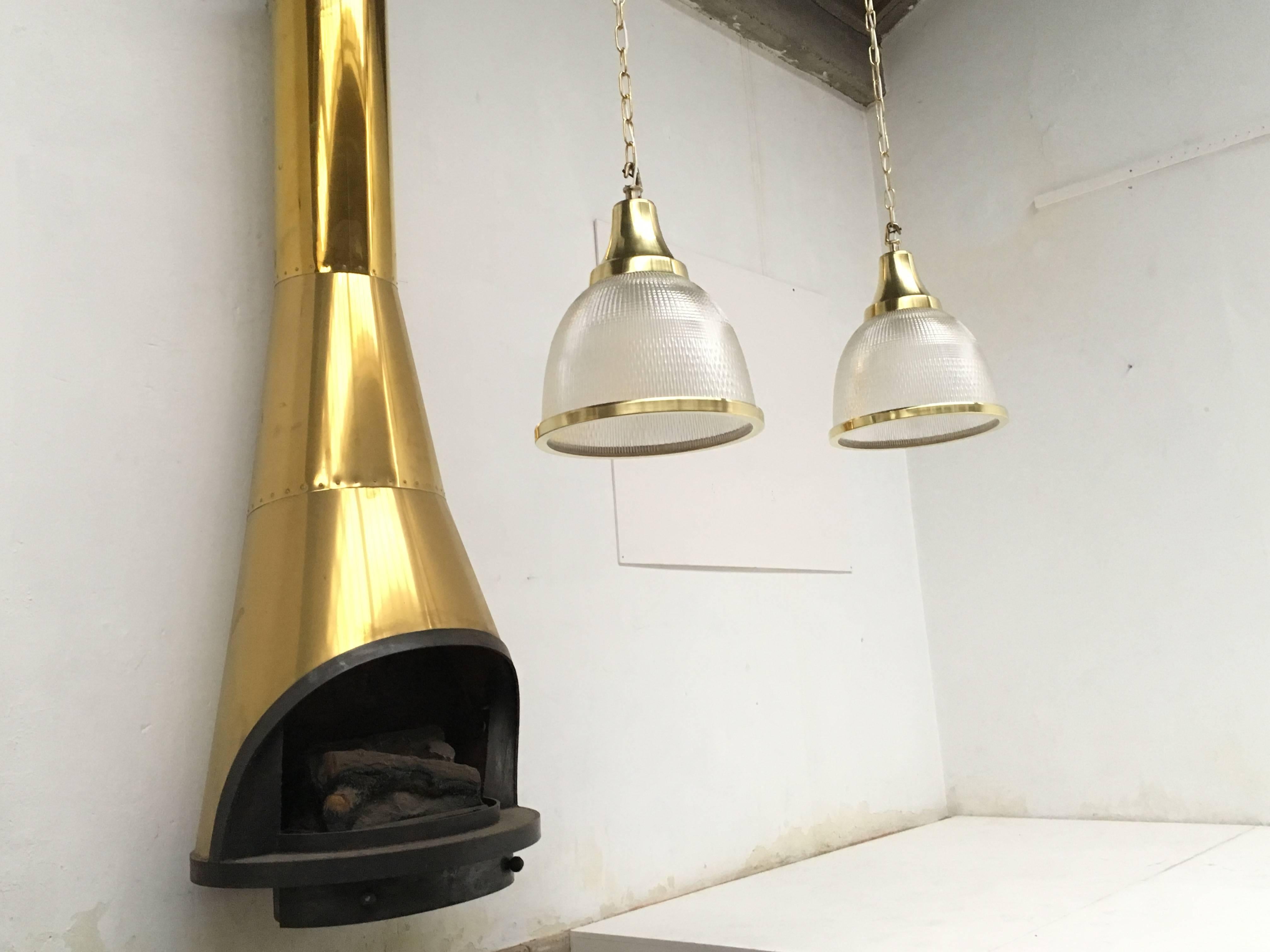 Pair of impressive Holophane glass and brass pendants from a Belgian church.

We polished the brass and rewired this pair completely and have another four pieces extra in stock (not yet polished and rewired).

Price listed is for two