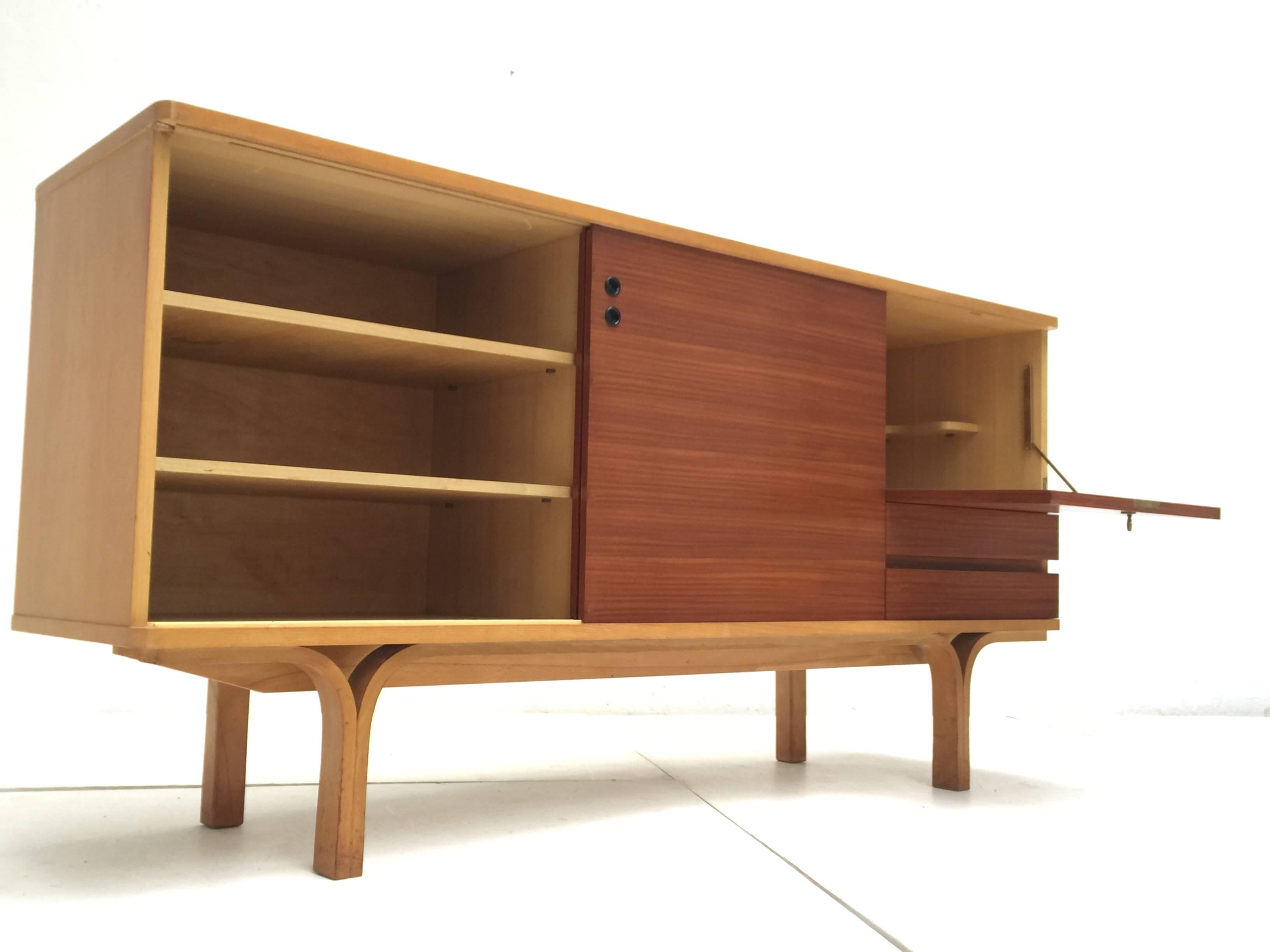 Rare and supremely elegant, ash and mahogany wood, credenza bar designed by Joseph Andre Motte in 1954 for 'Group 4, Charron,' France; complete with the extremely rare original decorative brass key for the lockable bar compartment.

 The
