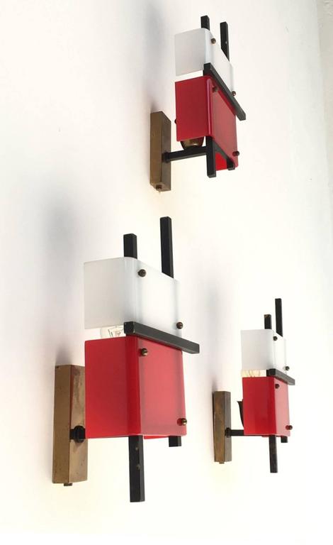 Stunning and super rare triptych of jewel like appliques finished in plexiglass and brass attributed to Angelo Lelli for Arredoluce, circa 1956. These appliques feature a stunning suprematist/constructivist style art form showing the influence of