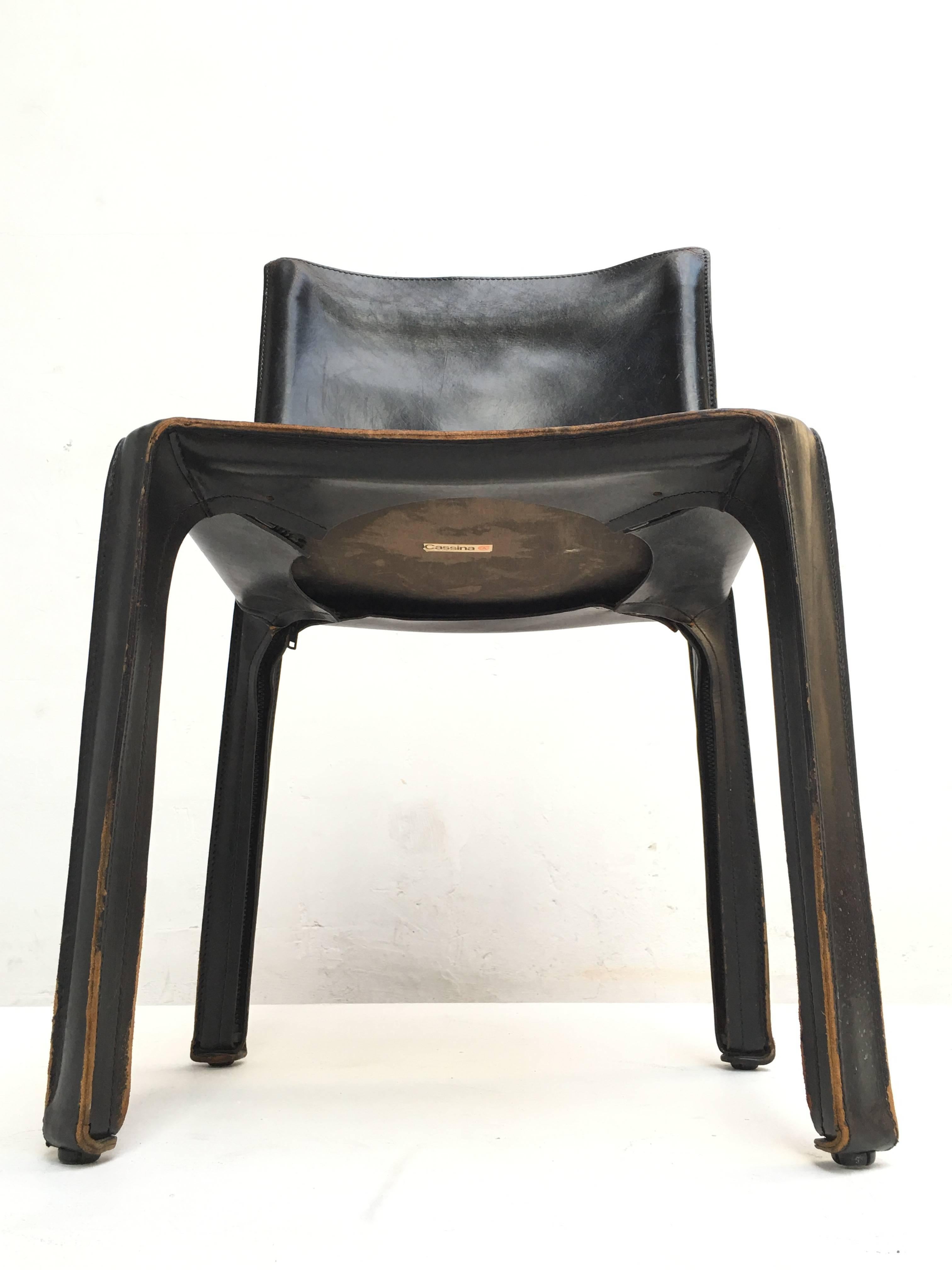 Verry nice set of eight 'CAB' dining chairs designed by Mario Bellini in 1977 finished in black leather over steel frames. The leather is original and has lovely patination. Some of the chairs still retain the original early Cassina labels located