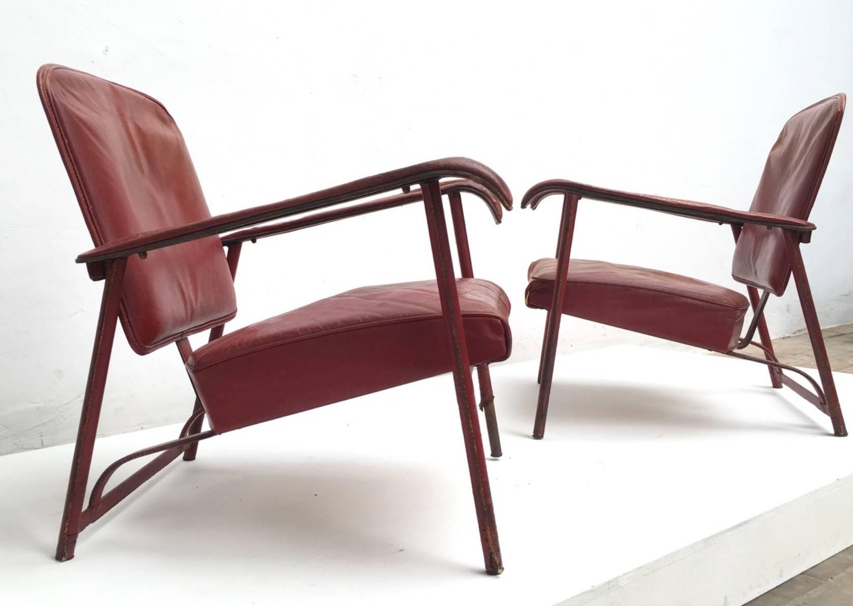 Supremely elegant pair of Jacques Adnet lounge chairs requiring restoration, the pair are currently finished in their original hand stitched leather complete with original patinated brass hardware (please see image 6).

The chairs are sold in their