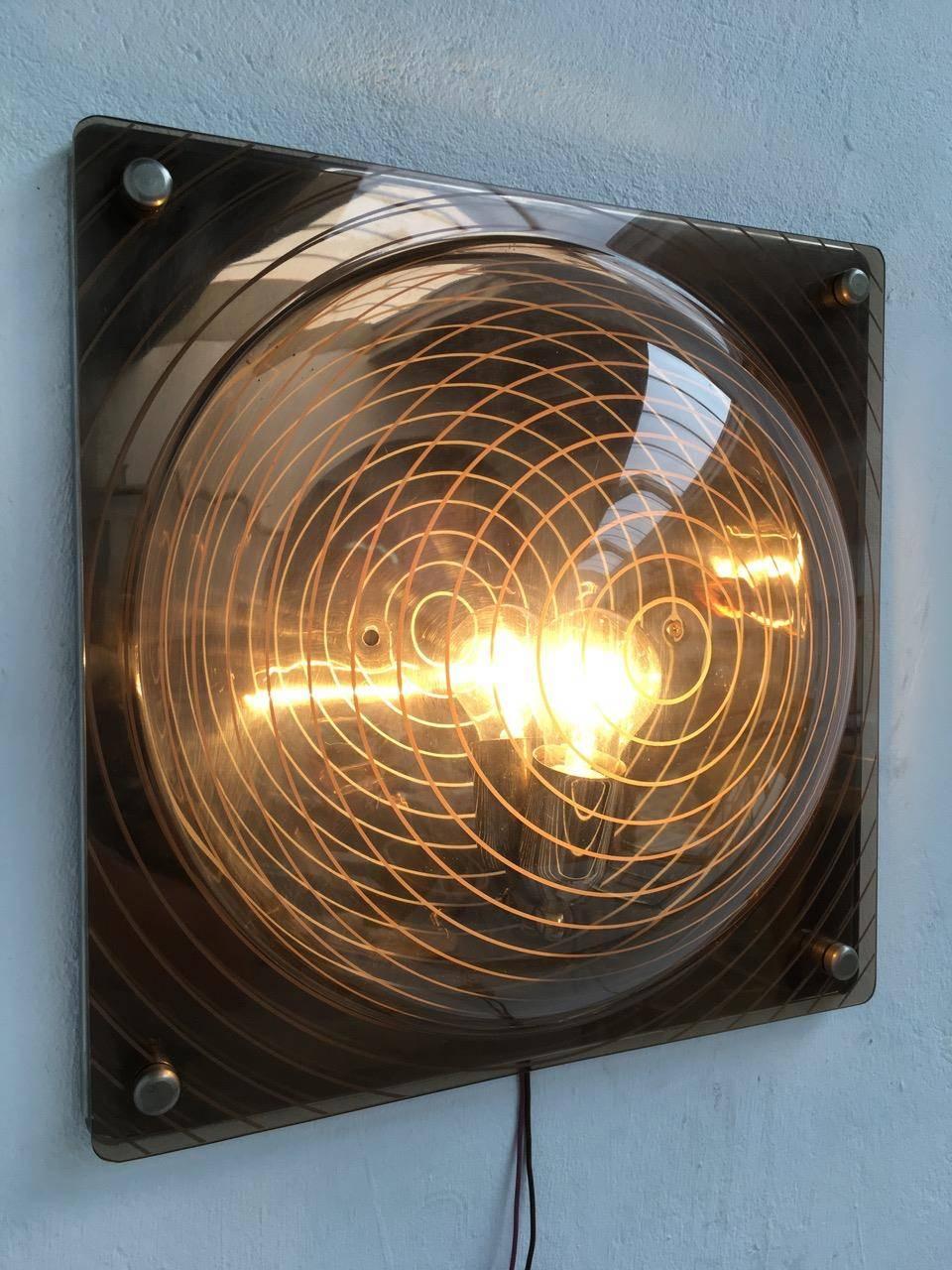 Rare and wonderful light sculpture in the style of important Italian Avant Garde artist Ugo La Pietra. This wall lamp clearly takes its cue from Ugo La Pietra's 'strutturazioni tissurali' studies of the mid-1960s where incised patterns were cut into