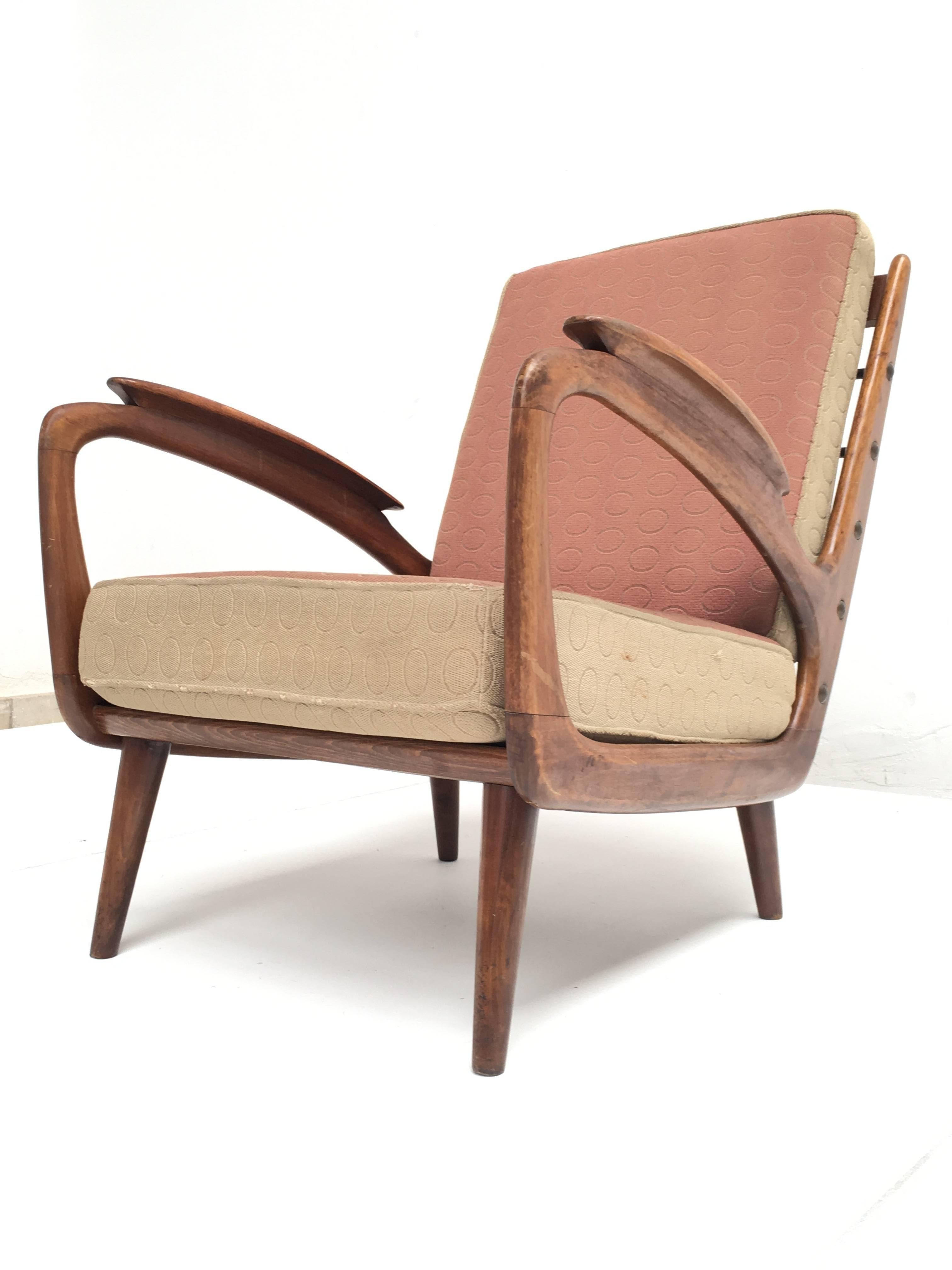 This lounge chair is most likely produced by Dutch Manufacturer 'De Ster' who was the predecessor of Gelderland and produced stunning top quality organic Scandinavian styled furniture in the 1950s

The frame is made of solid carved and walnut